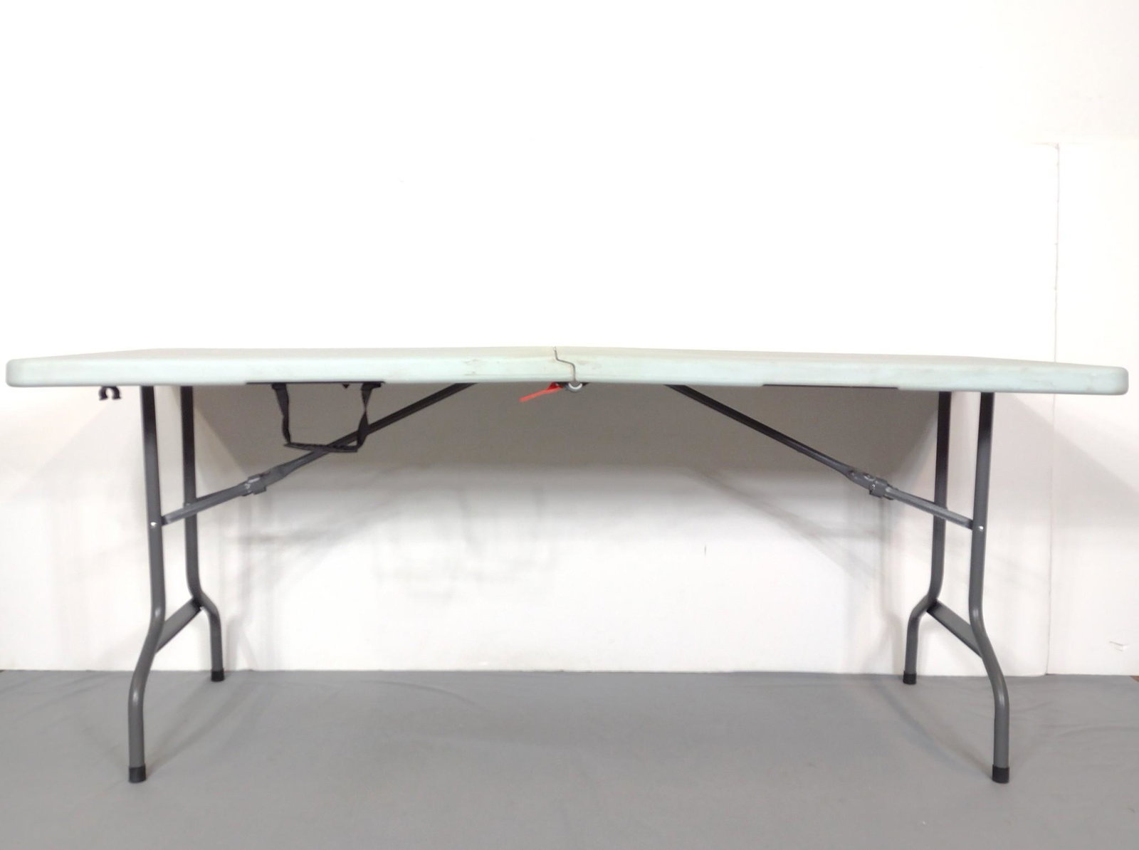 6ft Folding Table: 72" wide X 30" deep X 29-1/4" high. No manufactures name found. Has some scratches and discoloring. MG. IMPORTANT: Before bidding, please read the terms and conditions. When you registered for the auc