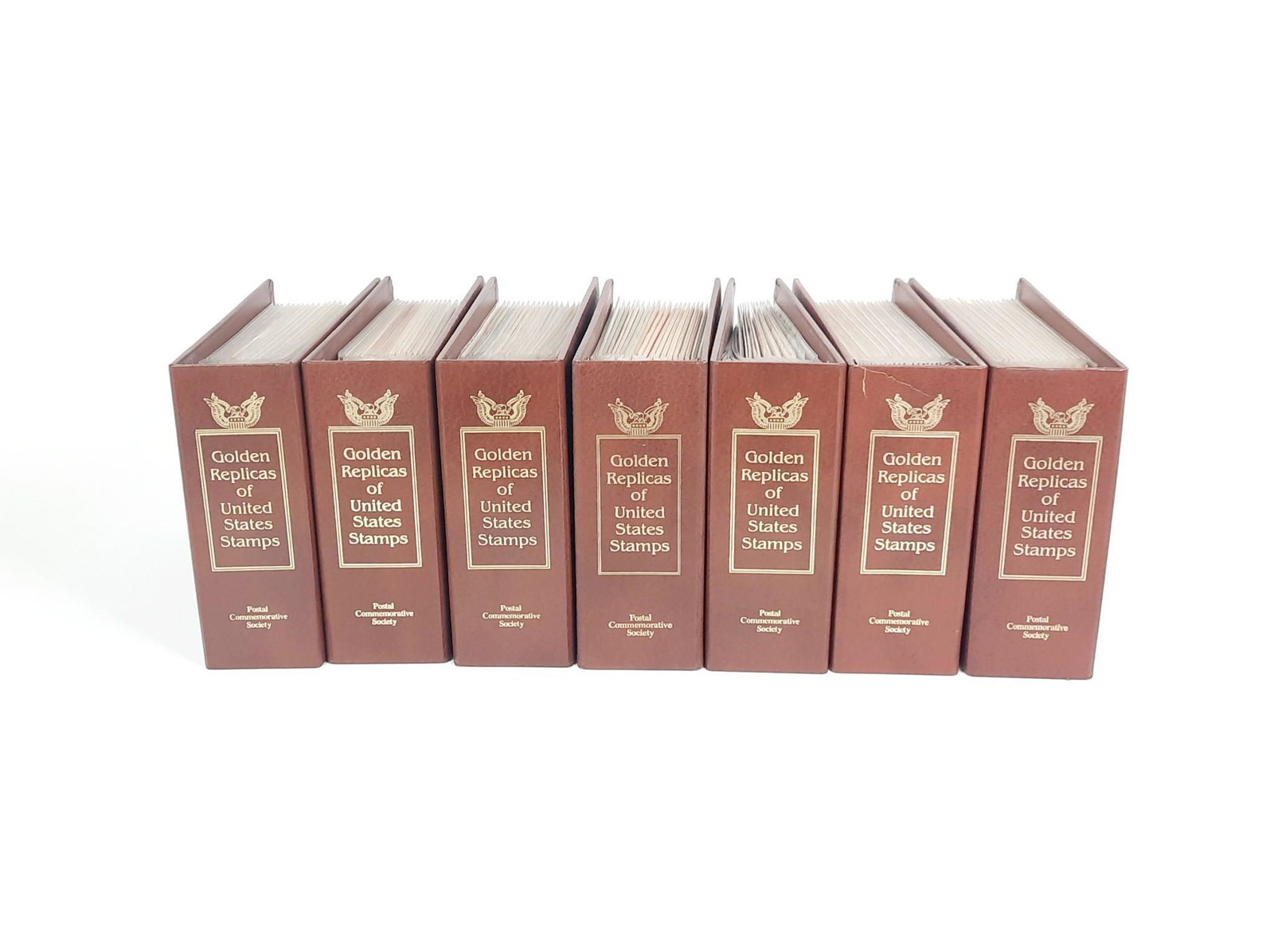 7 Golden Replica Stamp Albums: Includes WWII, Olympics and Holiday. Tearyo one binder spine. LR IMPORTANT: Before bidding, please read the terms and conditions. When you registered for the auction you agreed to these terms and will