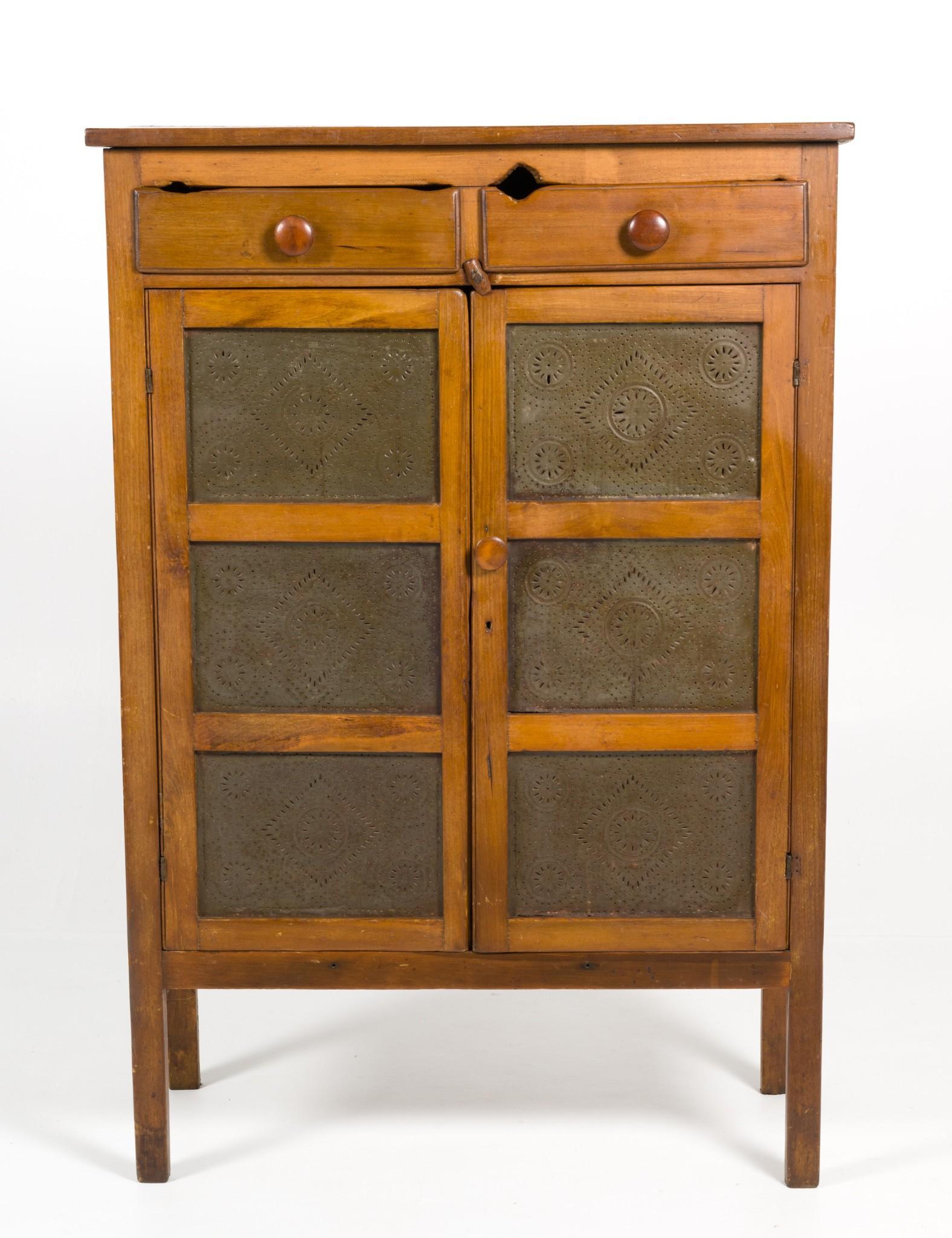 Punched Tin Pie Safe: DESCRIPTION: A softwood freestanding pie safe of Eastern or Midwestern United States. Rectangular case on four straight feet with two drawers beneath a single board top. The front with double paneled