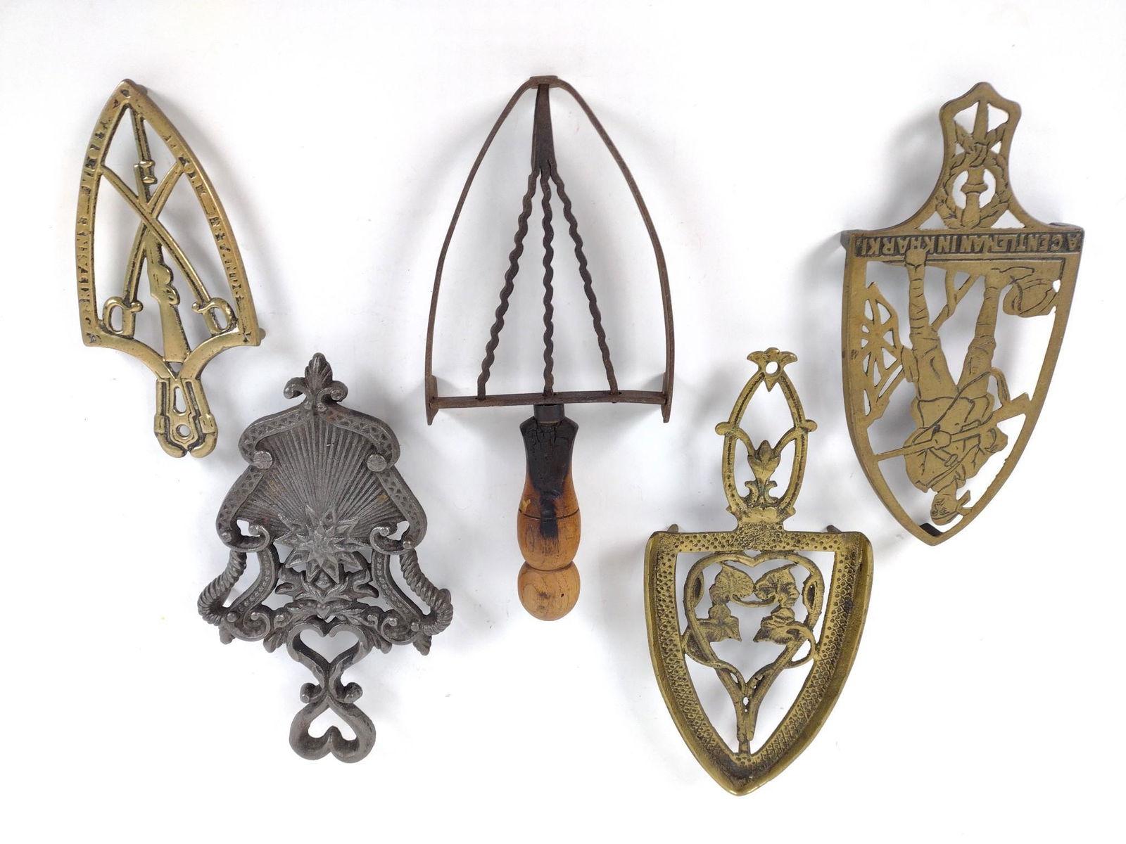 5 Antique Brass & Iron Trivets: 1" high x 3" to 5" wide x 7" to 10" deep. Includes "A Gentleman in Karki". JB IMPORTANT: Before bidding, please read the terms and conditions. When you registered for the auction you agreed to these t