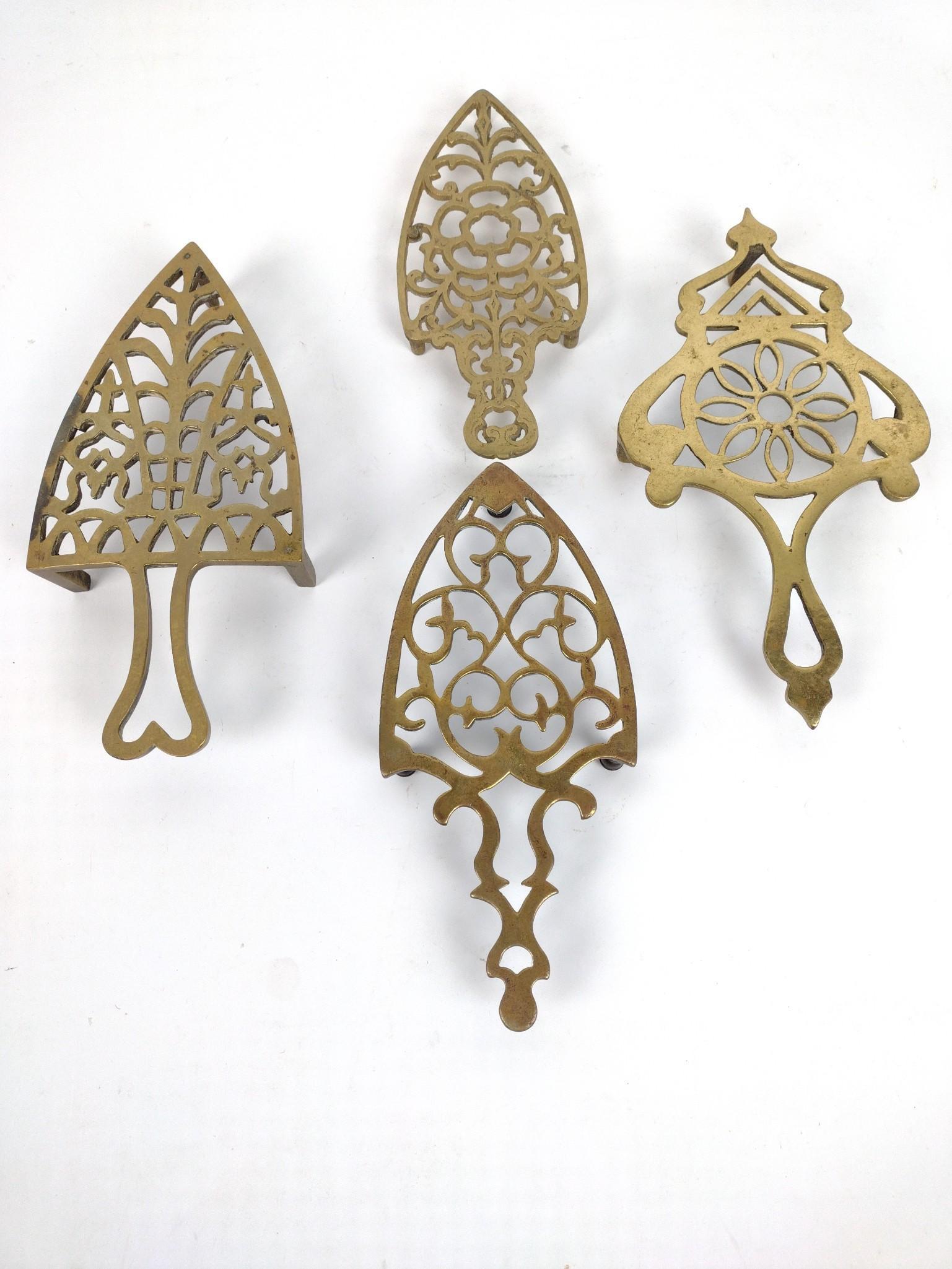 4 Antique Brass Trivets: 1/2" to 1-1/2" high, 3-1/4 to 5" wide, 7-1/2 to 9" deep. JB IMPORTANT: Before bidding, please read the terms and conditions. When you registered for the auction you agreed to these terms and will be r