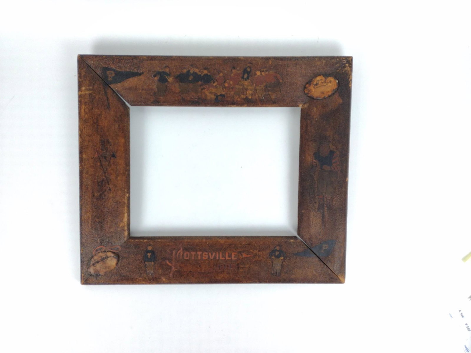 1909 Pottsville PA Folk Art Frame: 21" wide x 18" high, with football figures. JB IMPORTANT: Before bidding, please read the terms and conditions. When you registered for the auction you agreed to these terms and will be required to co