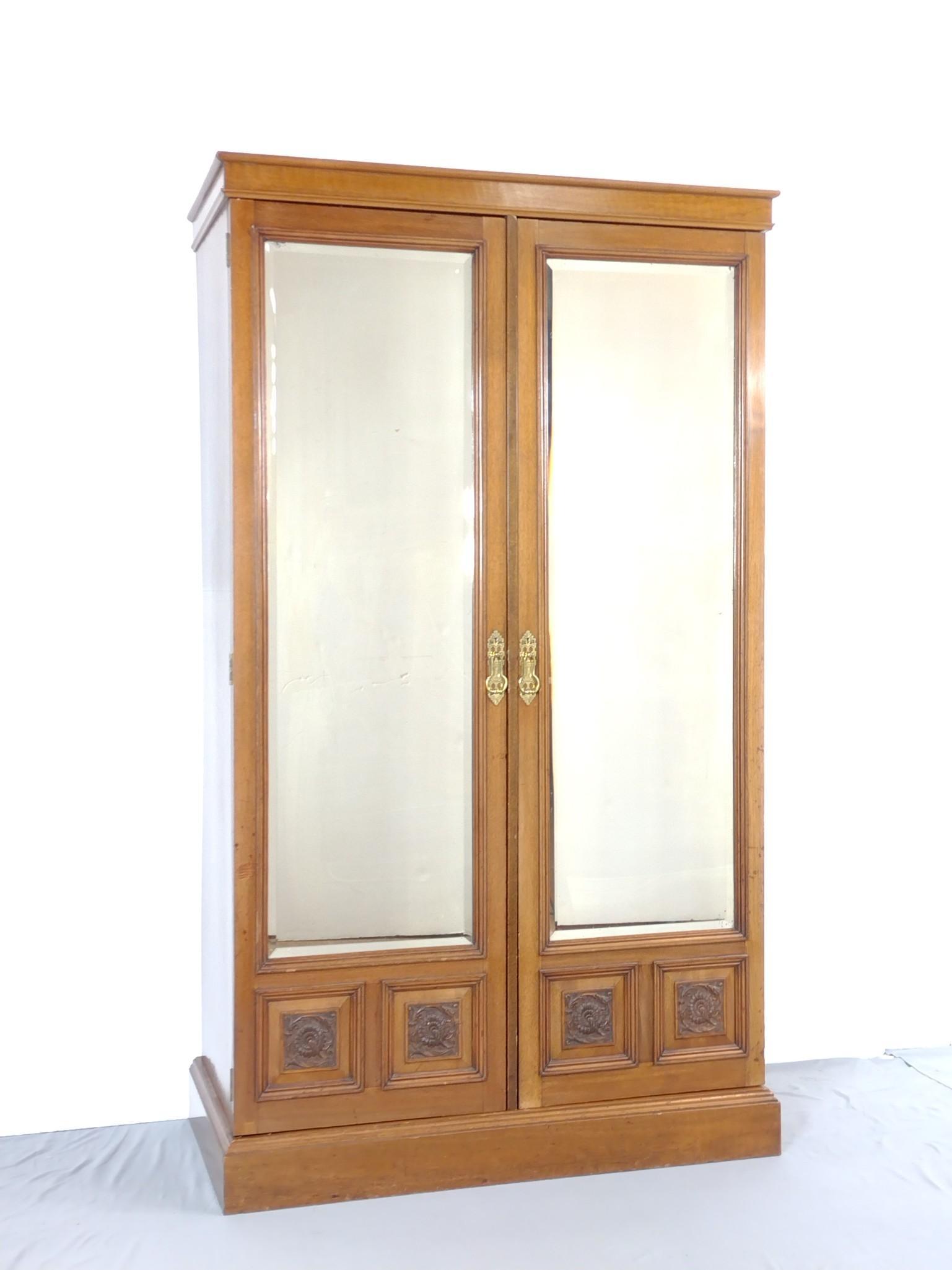 Mahogany Wardrobe: Mirrored and carved doors. 47" wide X 24" deep X 81" high. Has some light scratches. Inside has some water damage and some discoloring. MG. IMPORTANT: Before bidding, please read the terms and conditi