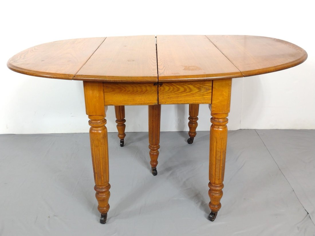Oak Drop Leaf Table: Open 57", closed 26" wide X 44" deep X 29" high. Has a few light scratches. MG. IMPORTANT: Before bidding, please read the terms and conditions. When you registered for the auction you agreed to these