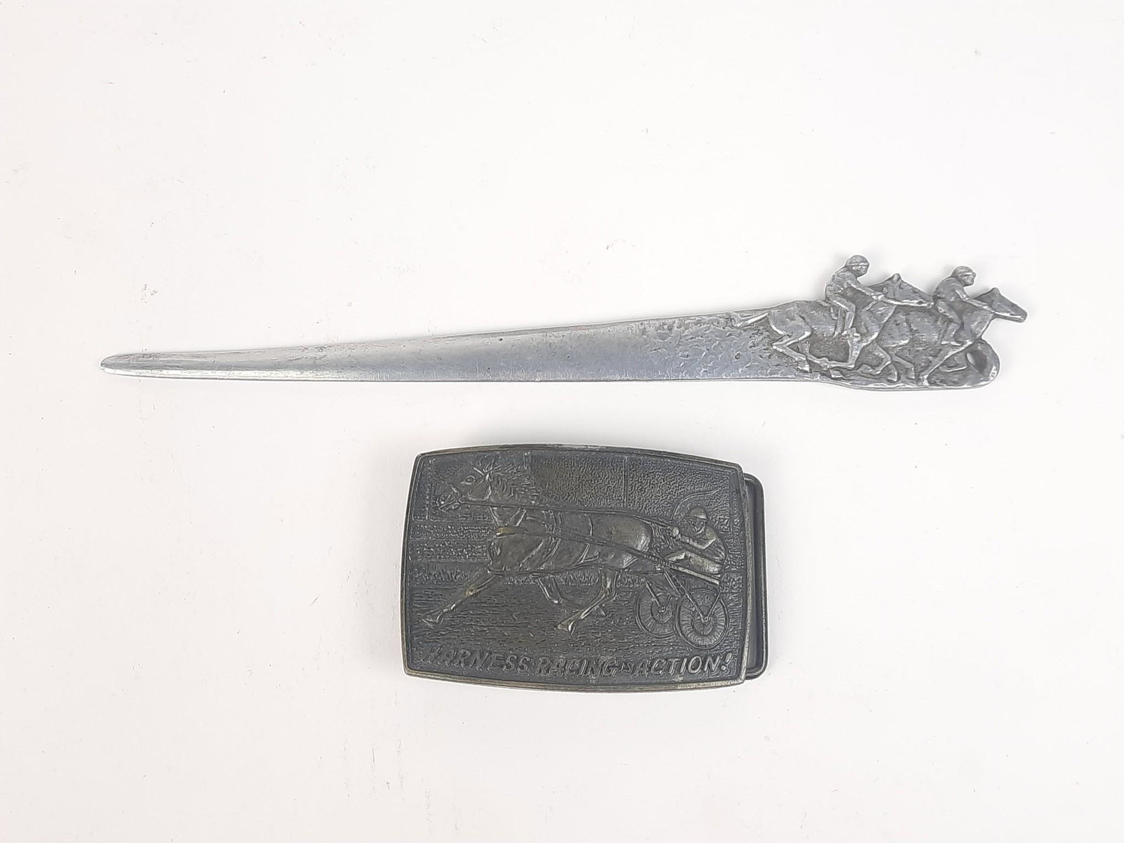 Horse Racing Belt Buckle and Letter Opener: 3-1/2" to 9-1/4" long. LR IMPORTANT: Before bidding, please read the terms and conditions. When you registered for the auction you agreed to these terms and will be required to comply with them.