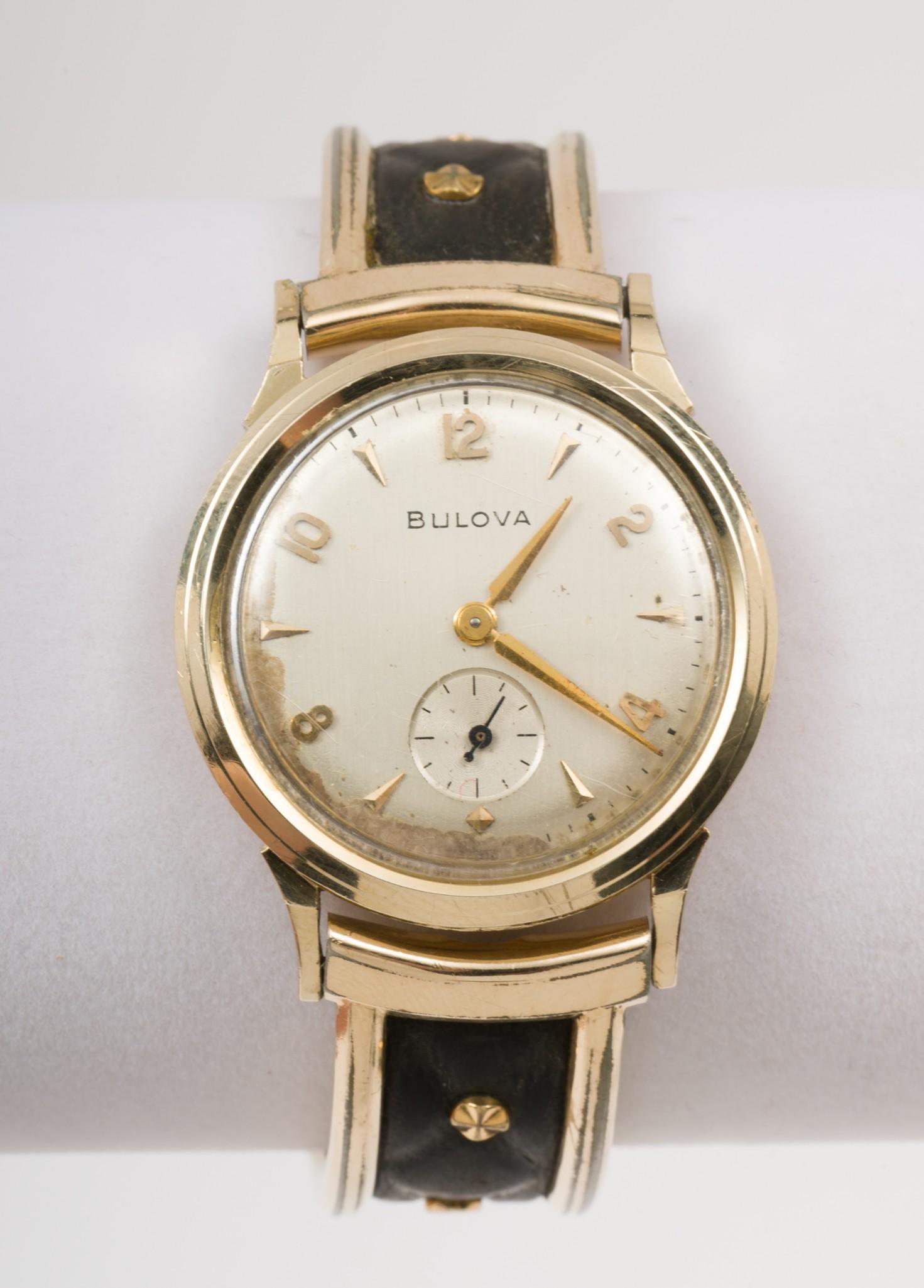 14K Bulova 21J Wristwatch: 21J 8AC movement with subsidiary second hand. Case stamped 14KT Bulova, serial number 5251222. On elastic bracelet. Missing crown. AJ/MH. IMPORTANT: Before bidding, please read the te