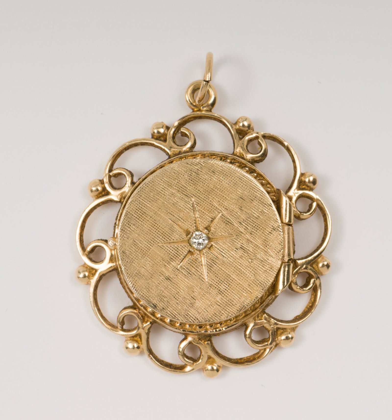 Vintage 14k Gold And Diamond Locket: Set with 2 pt diamond. Tests 14k. 1" wide. 4.2 dwt. AJ/MH. IMPORTANT: Before bidding, please read the terms and conditions. When you registered for the auction you agreed to these terms and will be re