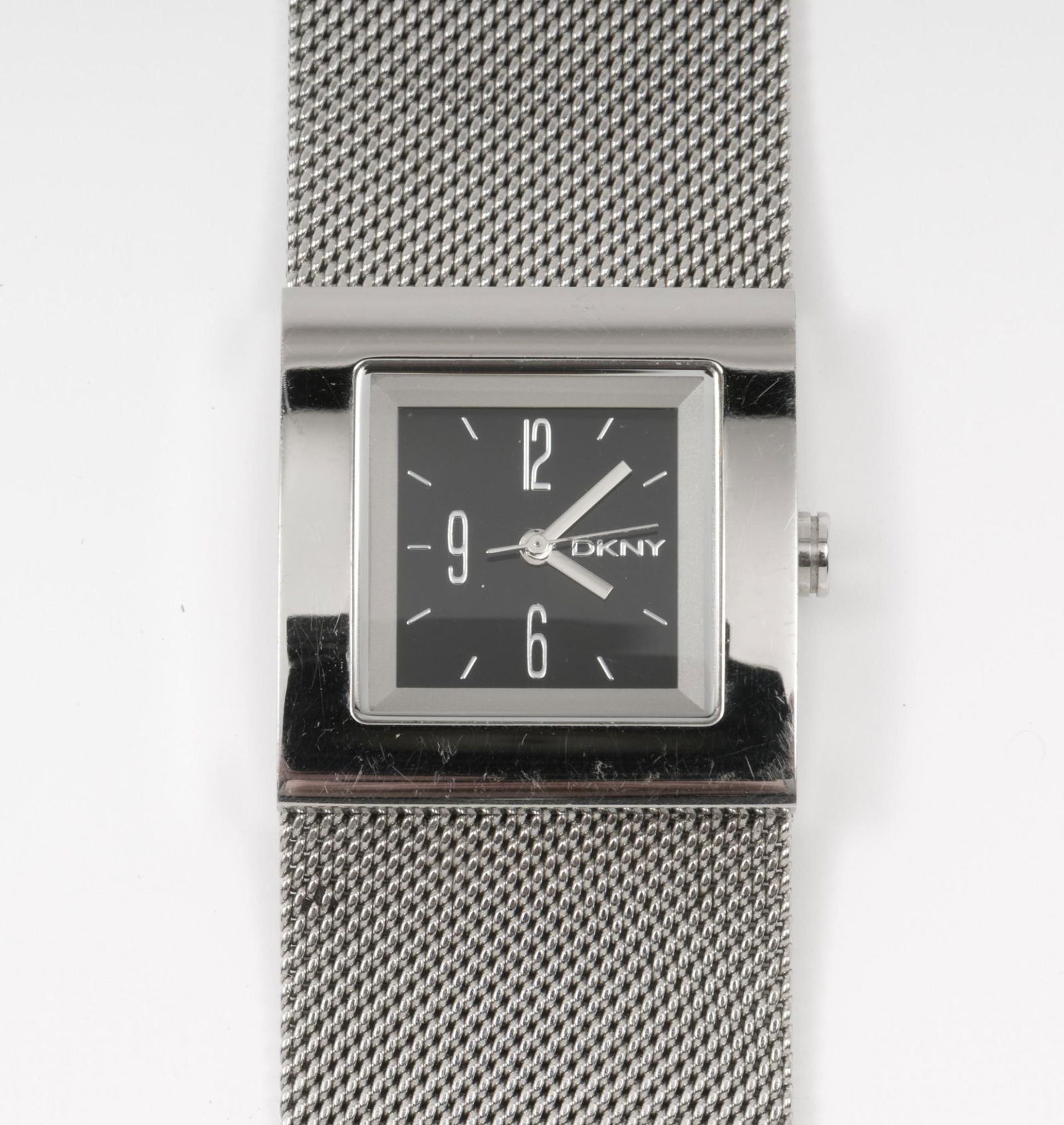 DKNY Model 6631 Ladies Fashion Wristwatch: Quartz movement. Stainless steel case and adjustable bracelet. 1-1/8" lug to lug. IMPORTANT: Before bidding, please read the terms and conditions. When you registered for the auction you agreed to the