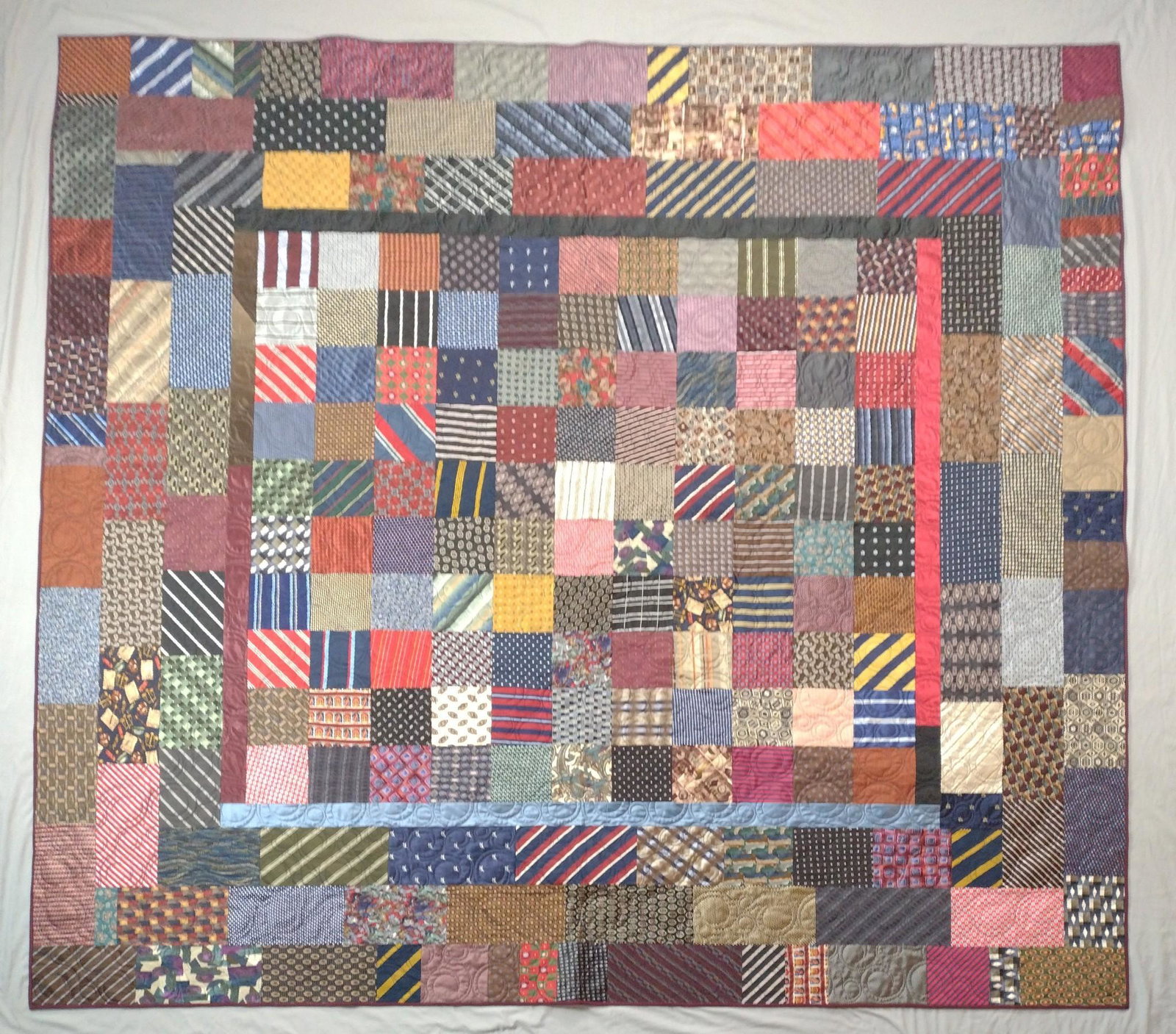 Patchwork Quilt: Made out of neckties. 84" wide x 88" long. JB IMPORTANT: Before bidding, please read the terms and conditions. When you registered for the auction you agreed to these terms and will be required to com