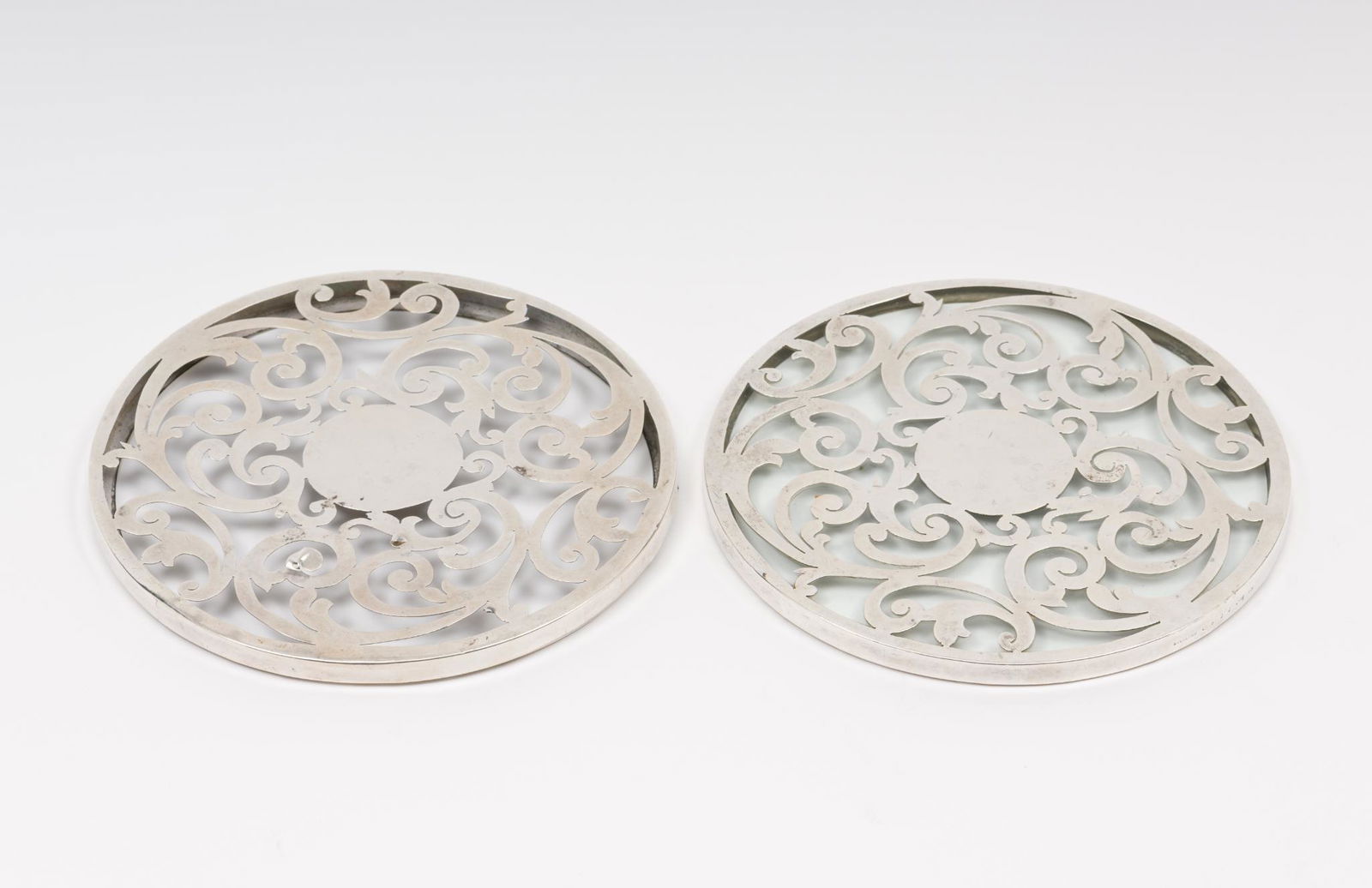 2 Sterling and Glass Trivets: Both marked sterling and for Dominick and Haff. One missing glass. 6" diam. 3/8" H. Sterling weight (one missing glass only) 1.9 ozt. DC/ML IMPORTANT: Before bidding, please read the terms and conditi