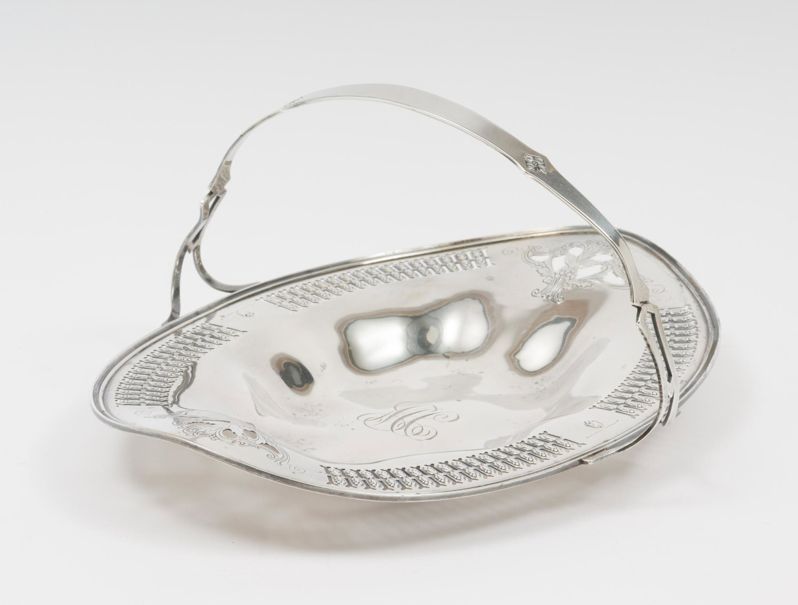 Oval Reticulated Cake Basket: Monogrammed to center, rounded handle. 9-3/4 x 6-1/2. 4-3/4" with handle. 7.2 ozt. DC/ML IMPORTANT: Before bidding, please read the terms and conditions. When you registered for the auction you agreed