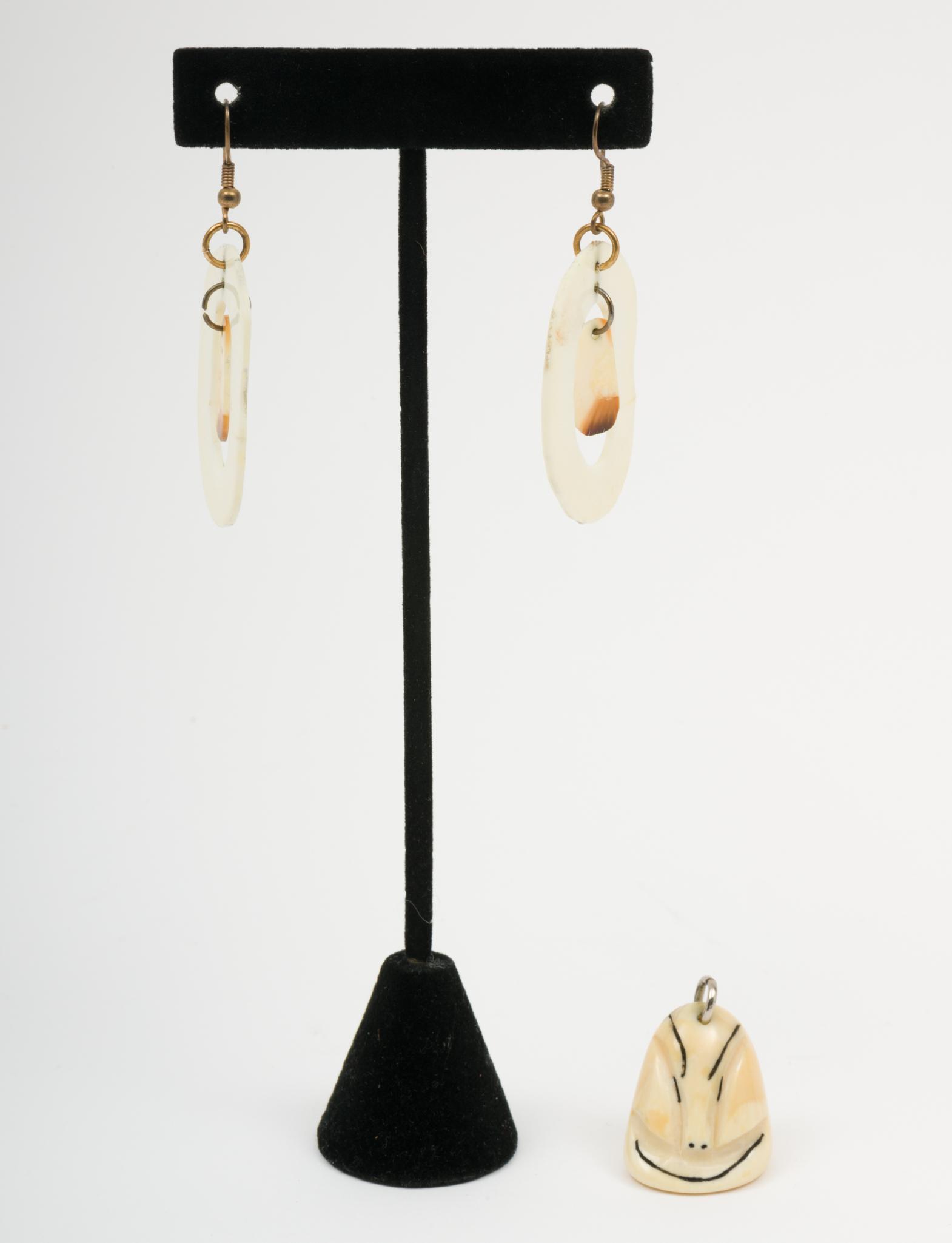 Alaskan Walrus Pendant and Earrings: Carved pendant and disc earrings. Pendant 1-1/4" Earrings 2-1/4". EK/ML IMPORTANT: Before bidding, please read the terms and conditions. When you registered for the auction you agreed to these terms a