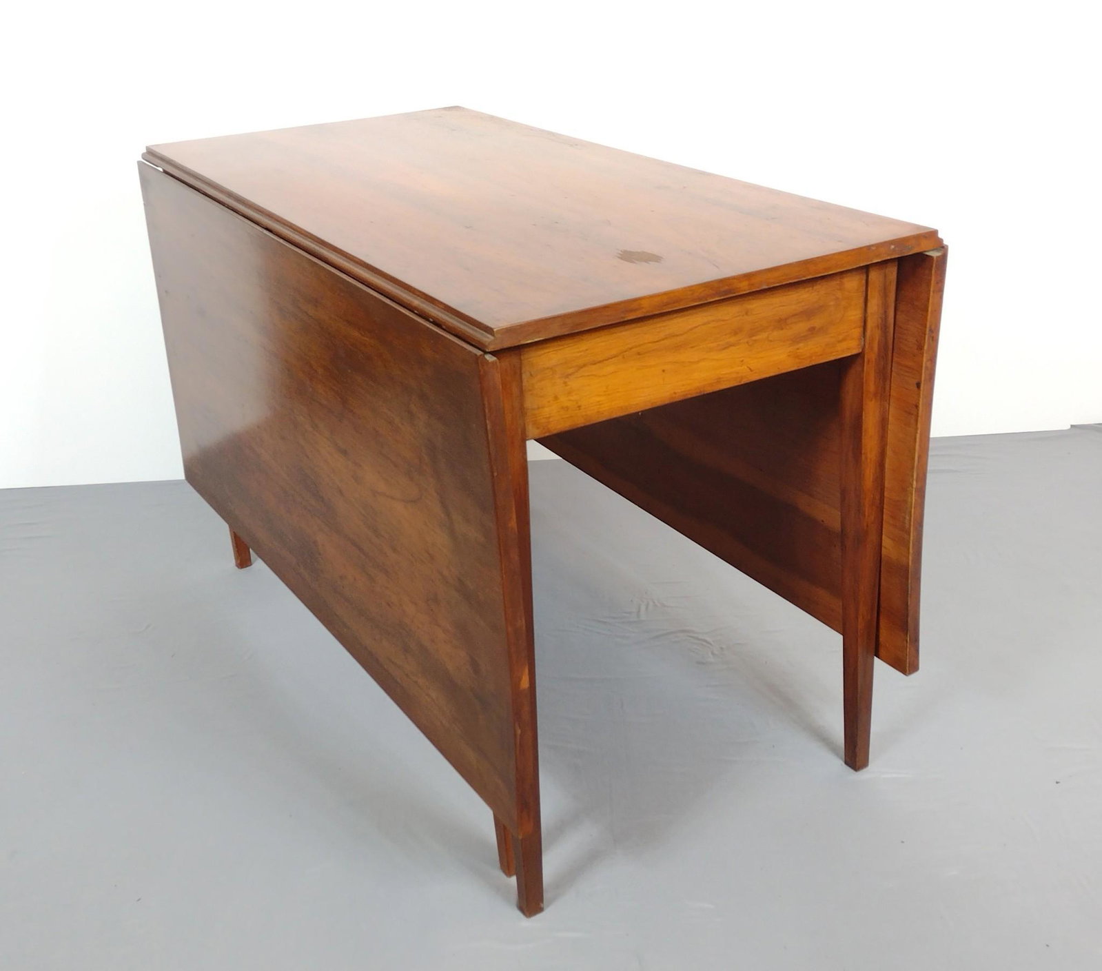 Gate Leg Dining Table: Open 67-1/4", closed 25" wide X 48" deep X 30" high. Has some scratches and areas of discoloring. Also has areas of finish loss. MG. Provenance: From the estate of Mary Trost who last resided in the m