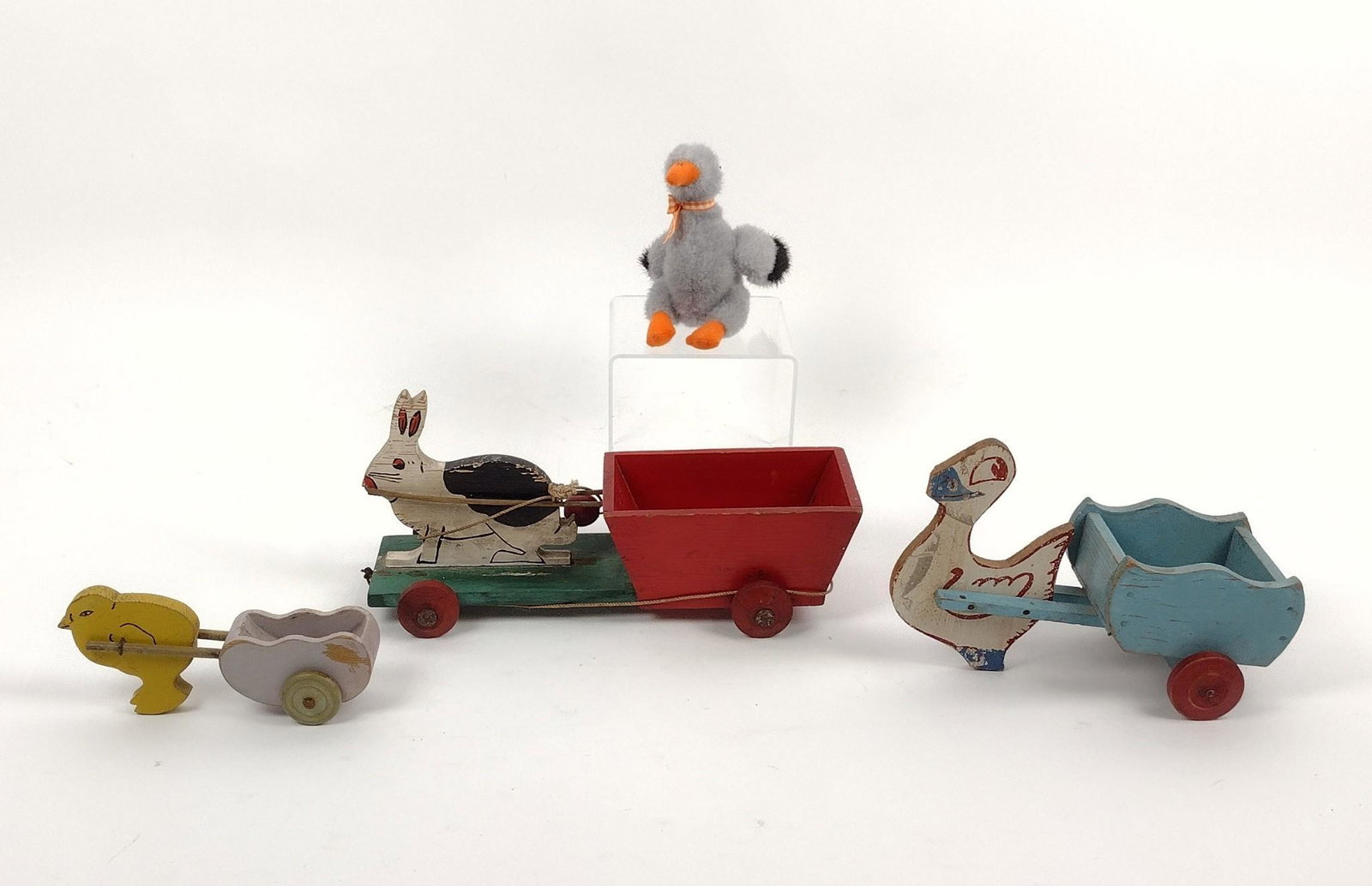 3 Wood Toy Carts & Stuffed Goose: 6-1/2" to 10" wide X 2-3/4" to 5" high. Some paint losses due to age and use. MEG Provenance: From the estate of Mary Trost who last resided in the multi generational family home located in Clarks Val