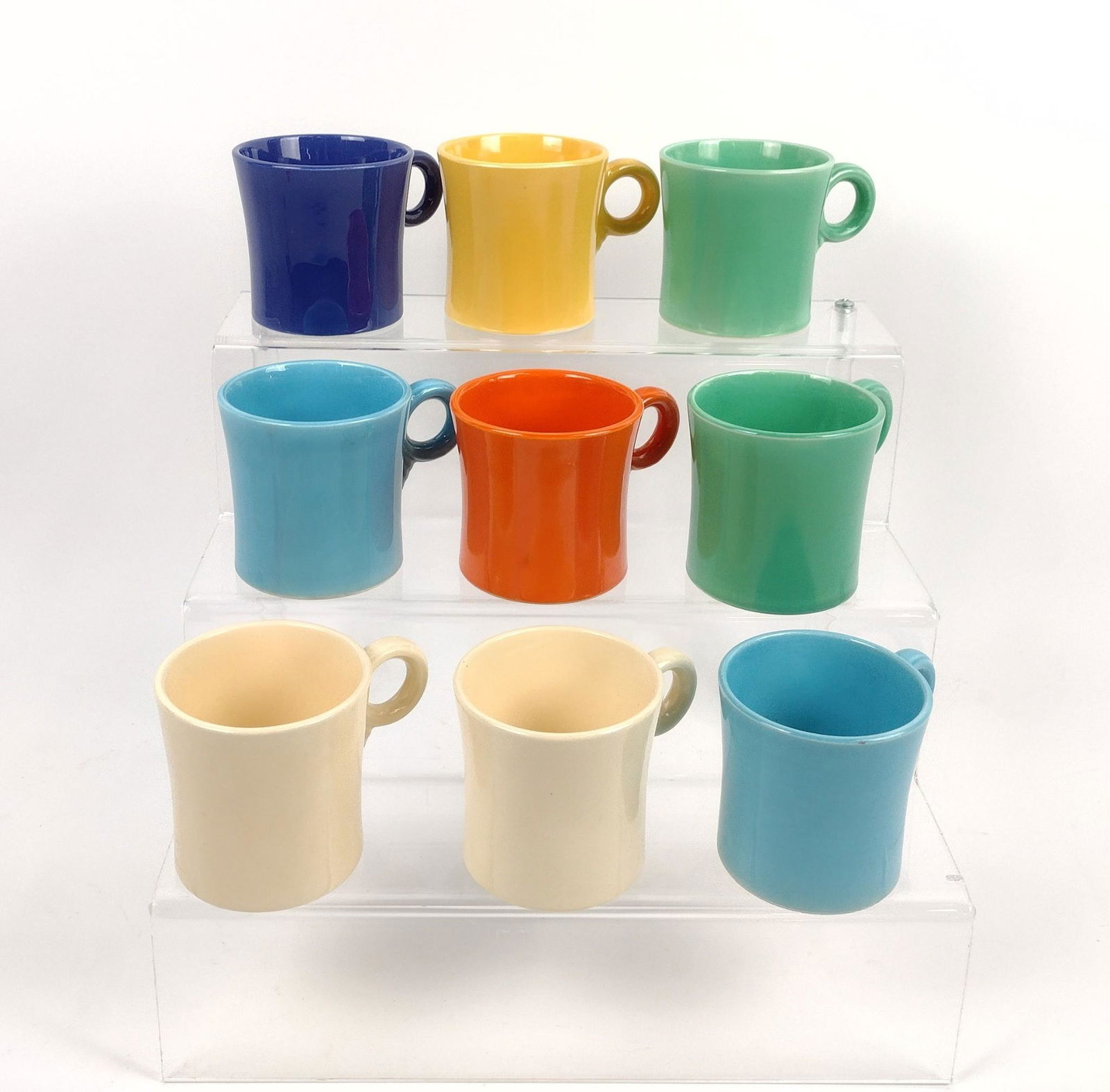 9 Fiestaware Mugs: 3" diameter X 3" high. MEG Provenance: From the estate of Mary Trost who last resided in the multi generational family home located in Clarks Valley, Dauphin (Harrisburg) Pennsylvania. Mrs. Trost was