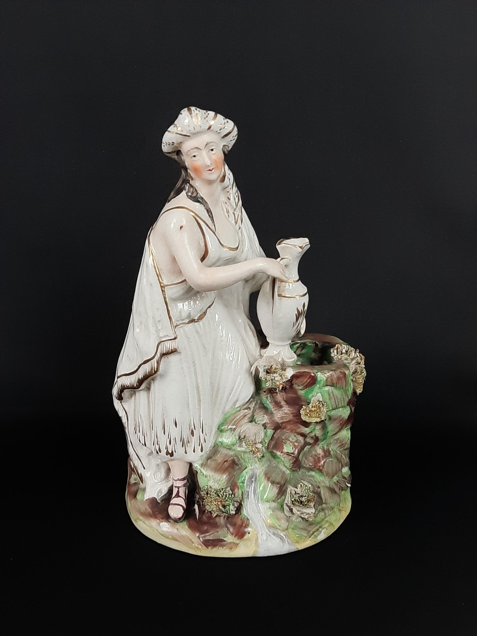 Staffordshire Rebecca Figurine: Unmarked. 5-1/2" wide x 4-1/4" deep x 8-3/4" high. LR Provenance: From the estate of Mary Trost who last resided in the multi generational family home located in Clarks Valley, Dauphin (Harrisburg) Pe
