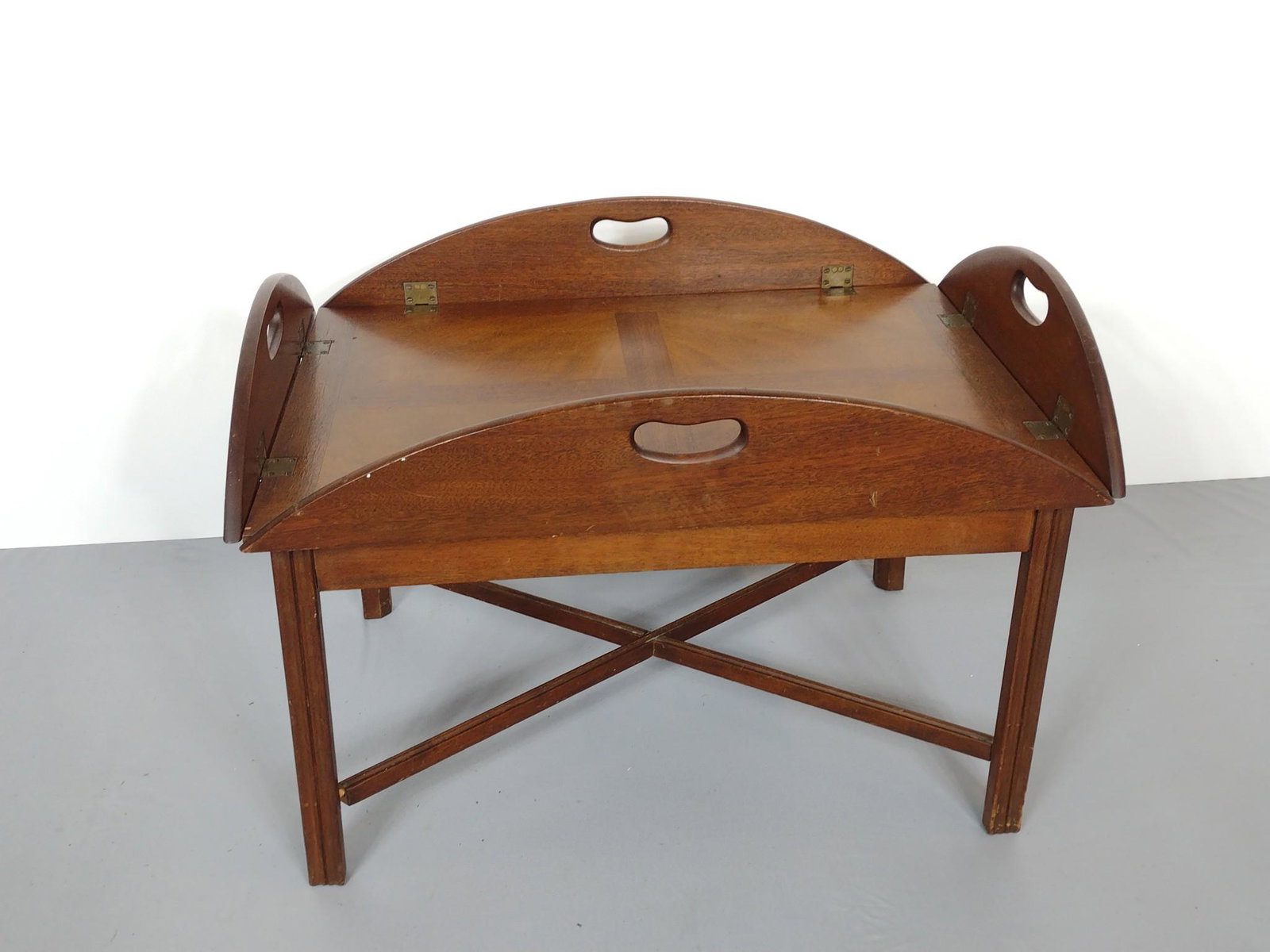 Butlers Tray Table: 40" wide X 31" deep X 16-1/2" high. Has some scratches and finish loss. Top has burn mark. No manufactures name found. MG. Provenance: From the estate of Mary Trost who last resided in the multi gener