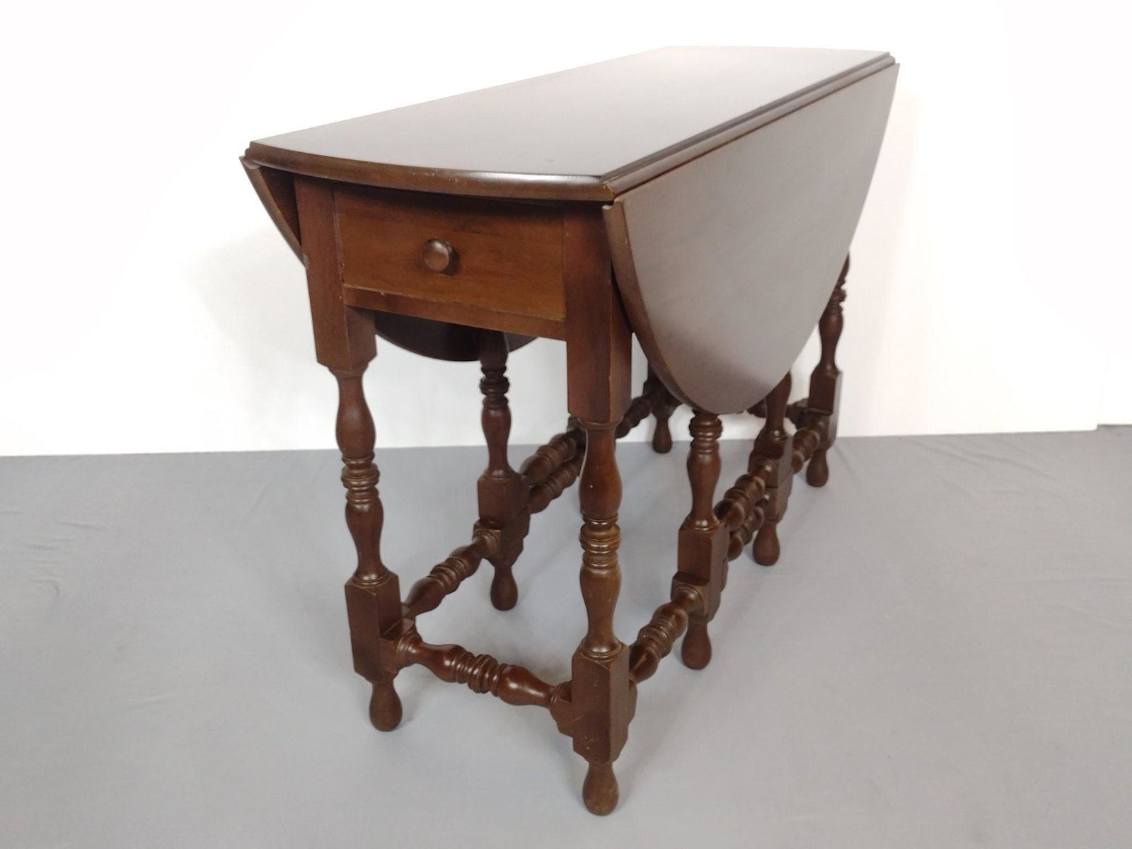 Gate Leg Table: Closed 15", open 42" wide X 42" deep X 28-3/4" high. Top has some scratches. MG. Provenance: From the estate of Mary Trost who last resided in the multi generational family home located in Clarks Vall