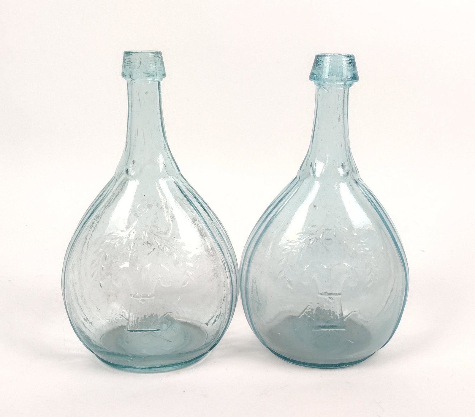 2 Harvest Wheat Glass Bottles: 5" wide X 9-1/4" high. MEG Provenance: From the estate of Mary Trost who last resided in the multi generational family home located in Clarks Valley, Dauphin (Harrisburg) Pennsylvania. Mrs. Trost was 