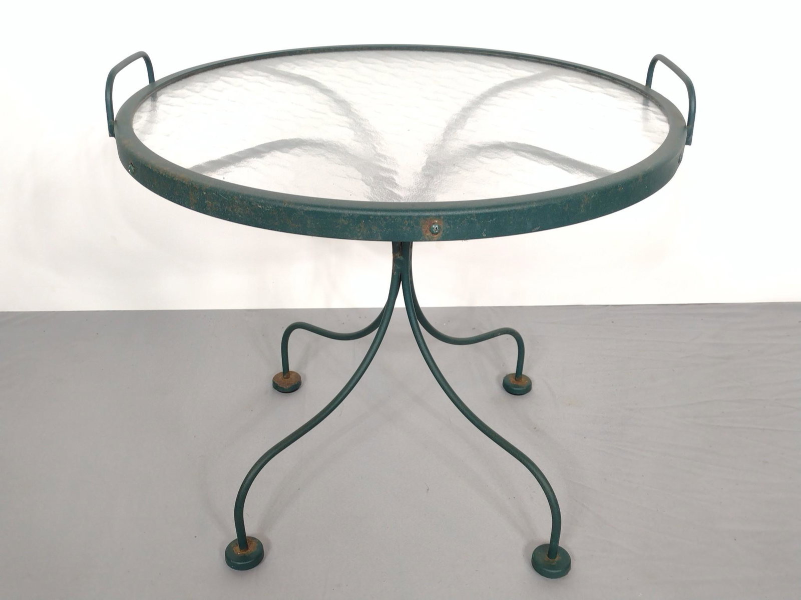 Glass Top Metal Outdoor Tray Table: 22-1/4" diameter X 18-1/2" high. Has some paint loss. MG. Provenance: From the estate of Mary Trost who last resided in the multi generational family home located in Clarks Valley, Dauphin (Harrisburg