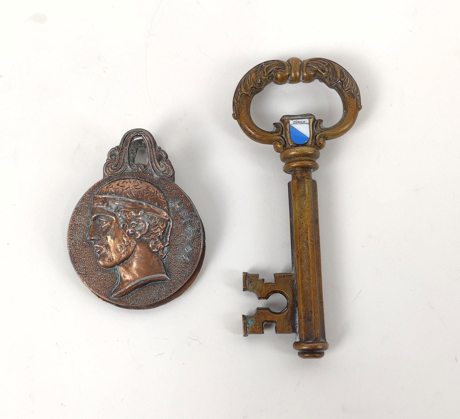 Brass Zurich Key & Brass Greek Coin Clip: 2-1/4" to 2-1/2" wide X 3-1/4" to 5-3/4" long. MEG Provenance: From the estate of Mary Trost who last resided in the multi generational family home located in Clarks Valley, Dauphin (Harrisburg) Penns