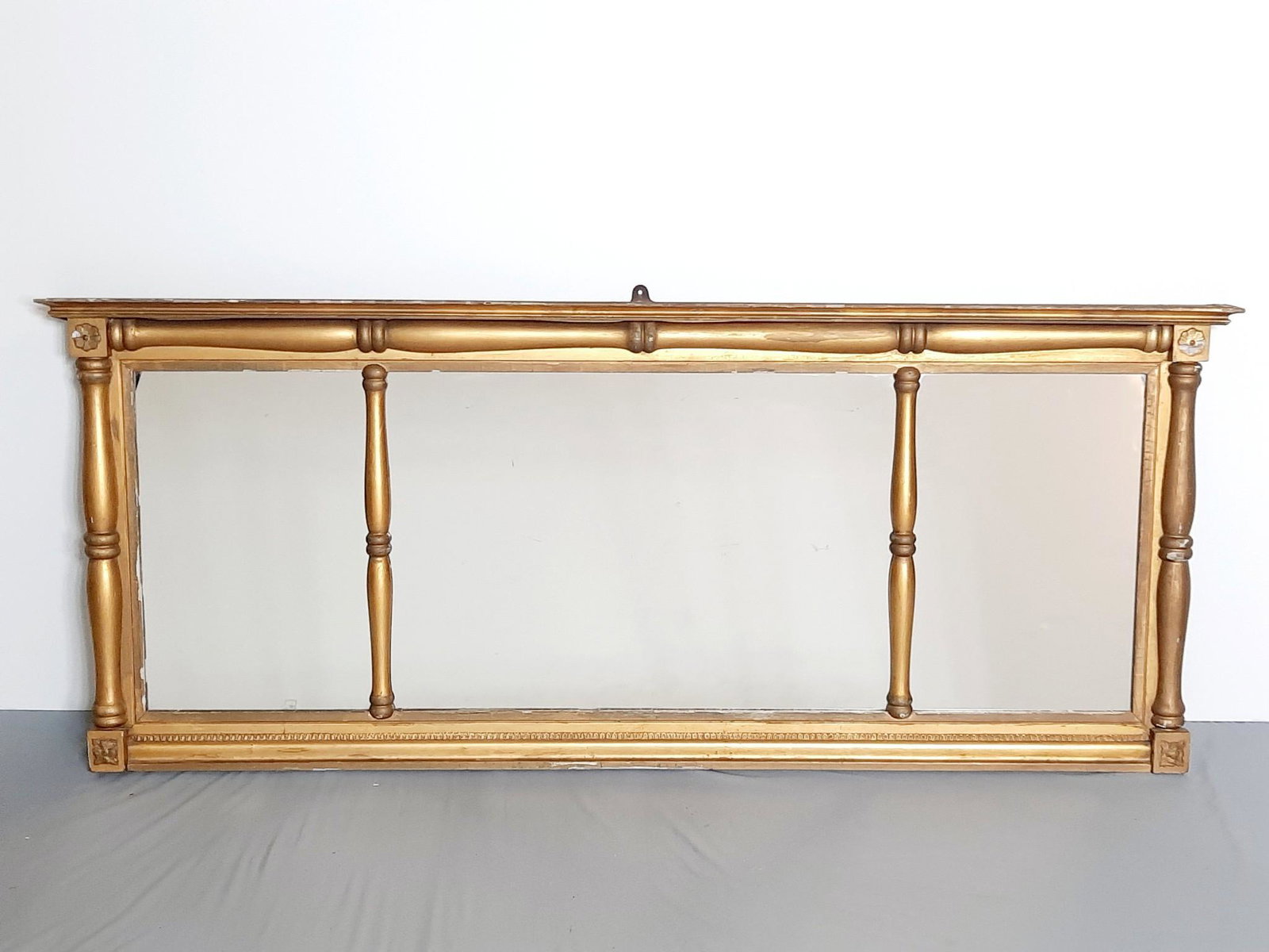 Antique Gilt Over Mantel Mirror: Overall with frame 25" high x 58" wide. Some paint losses. Provenance: From the estate of Mary Trost who last resided in the multi generational family home located in Clarks Valley, Dauphin (Harrisbur
