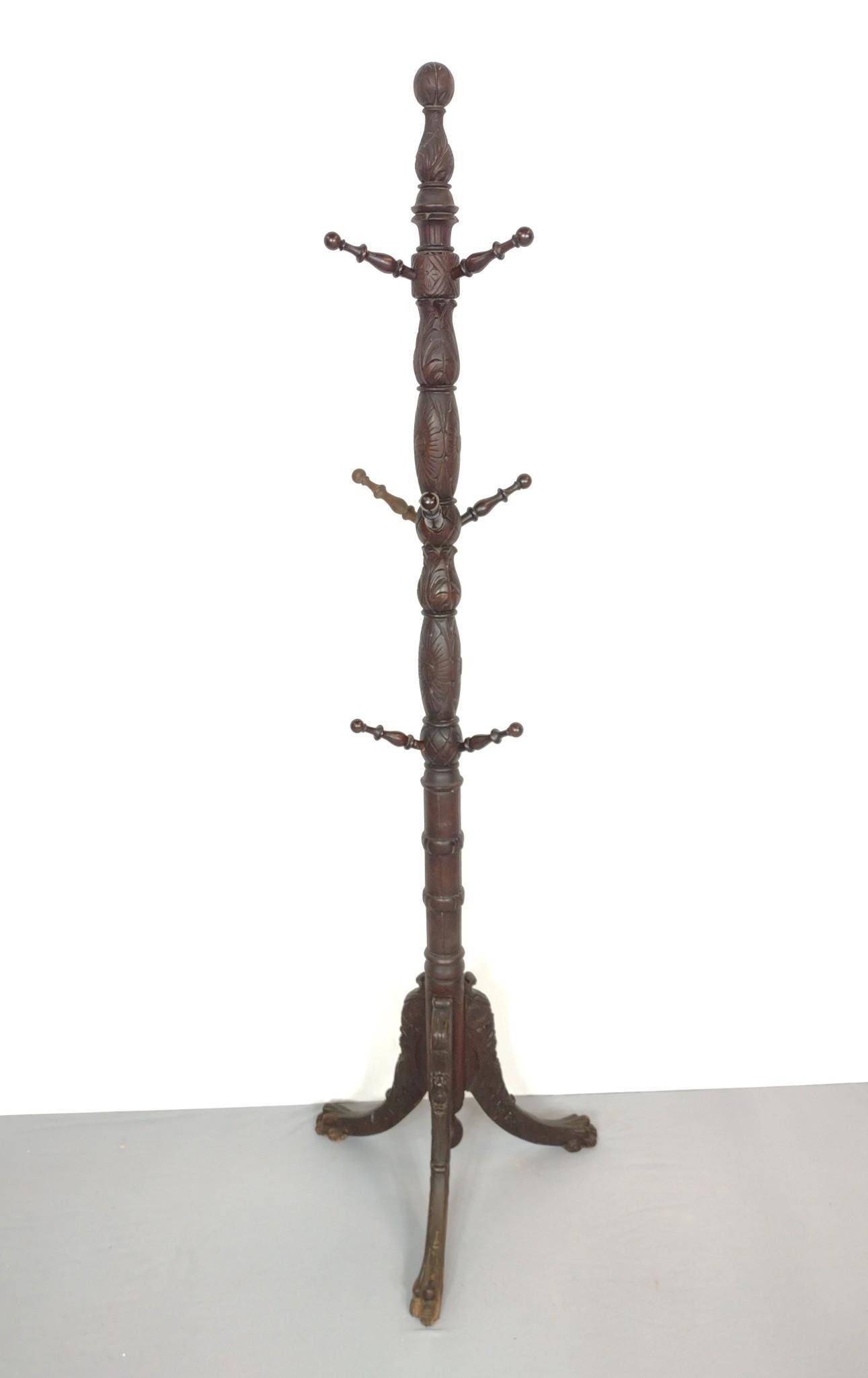 Carved Coat Tree: 21" diameter X 73" high. Has some light scratches. One peg repaired. MG. Provenance: From the estate of Mary Trost who last resided in the multi generational family home located in Clarks Valley, Daup
