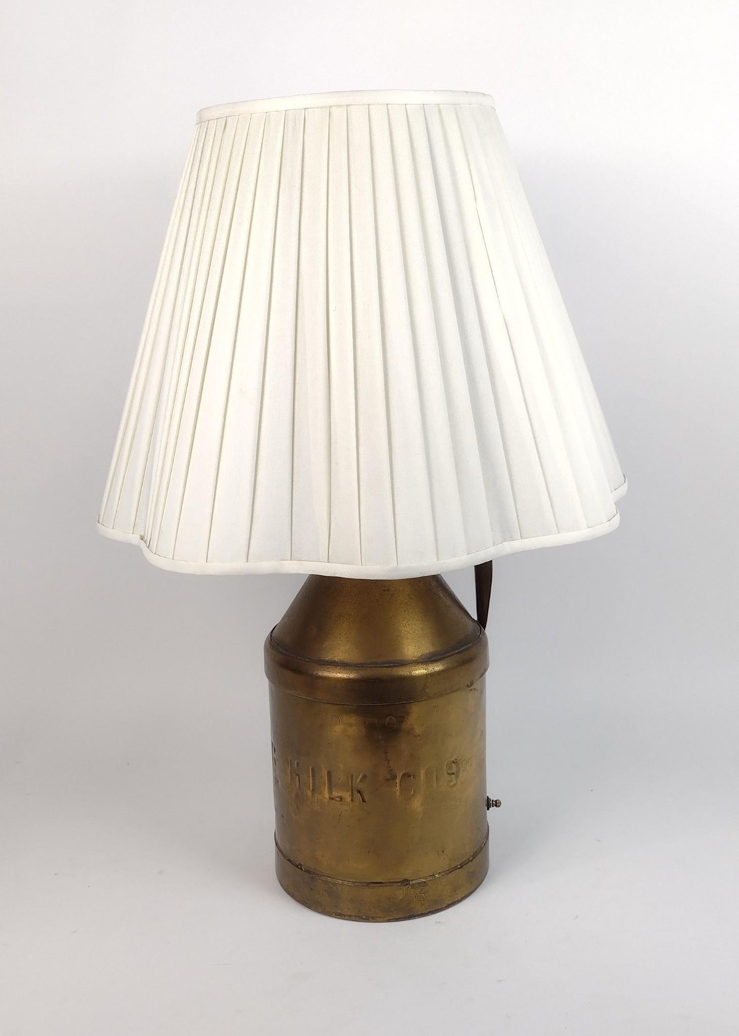 Milk Can Lamp: Working. With shade 18" diameter x 27" high. JB IMPORTANT: Before bidding, please read the terms and conditions. When you registered for the auction you agreed to these terms and will be required to c