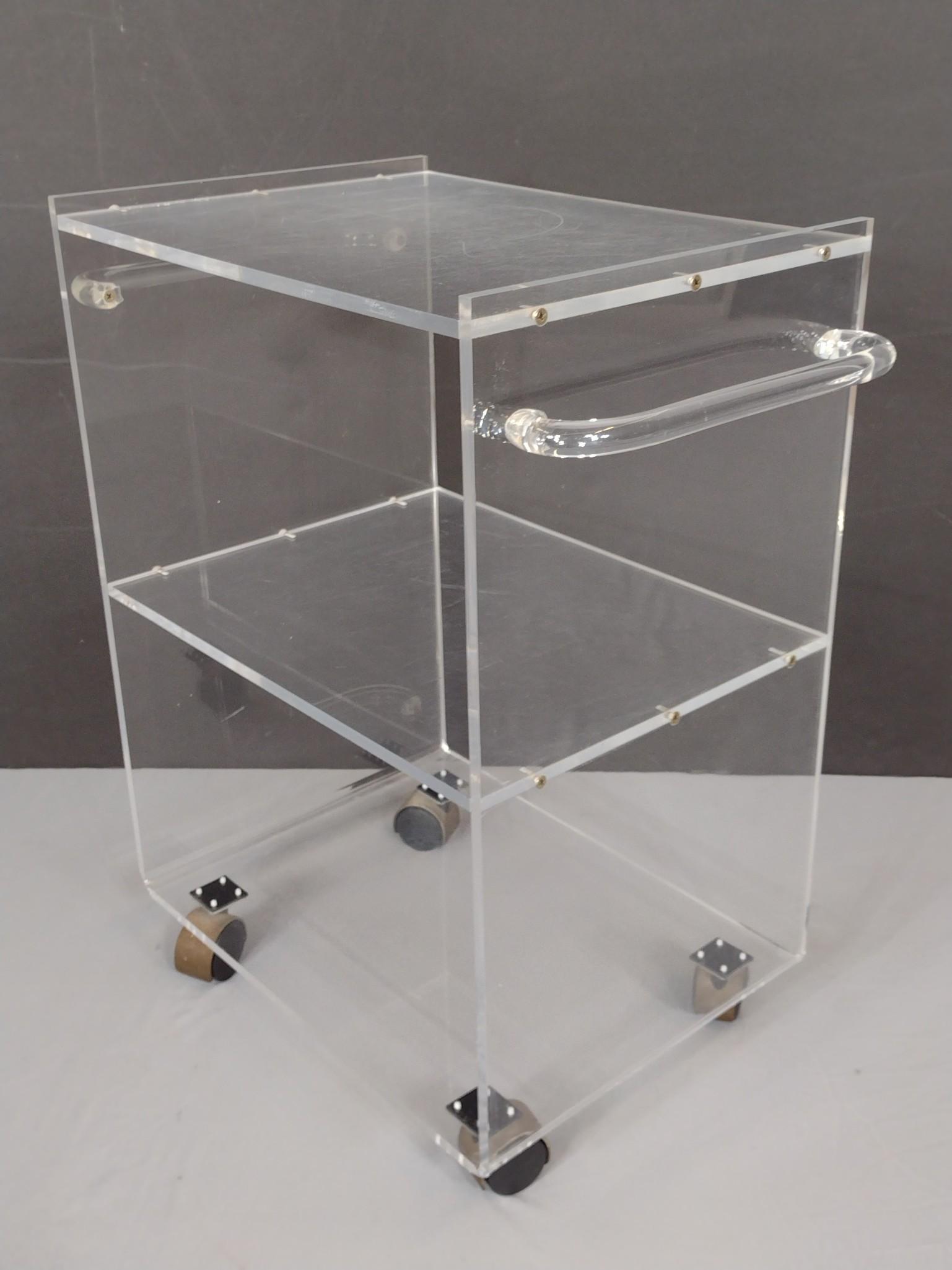 Lucite Rolling Cart: 23" wide X 14" deep X 26-3/4" high. Has some scratches. No manufactures name found. MG. From the estate of Lois Lehrman Grass Harrisburg, PA. IMPORTANT: Before bidding, please read the terms and condi