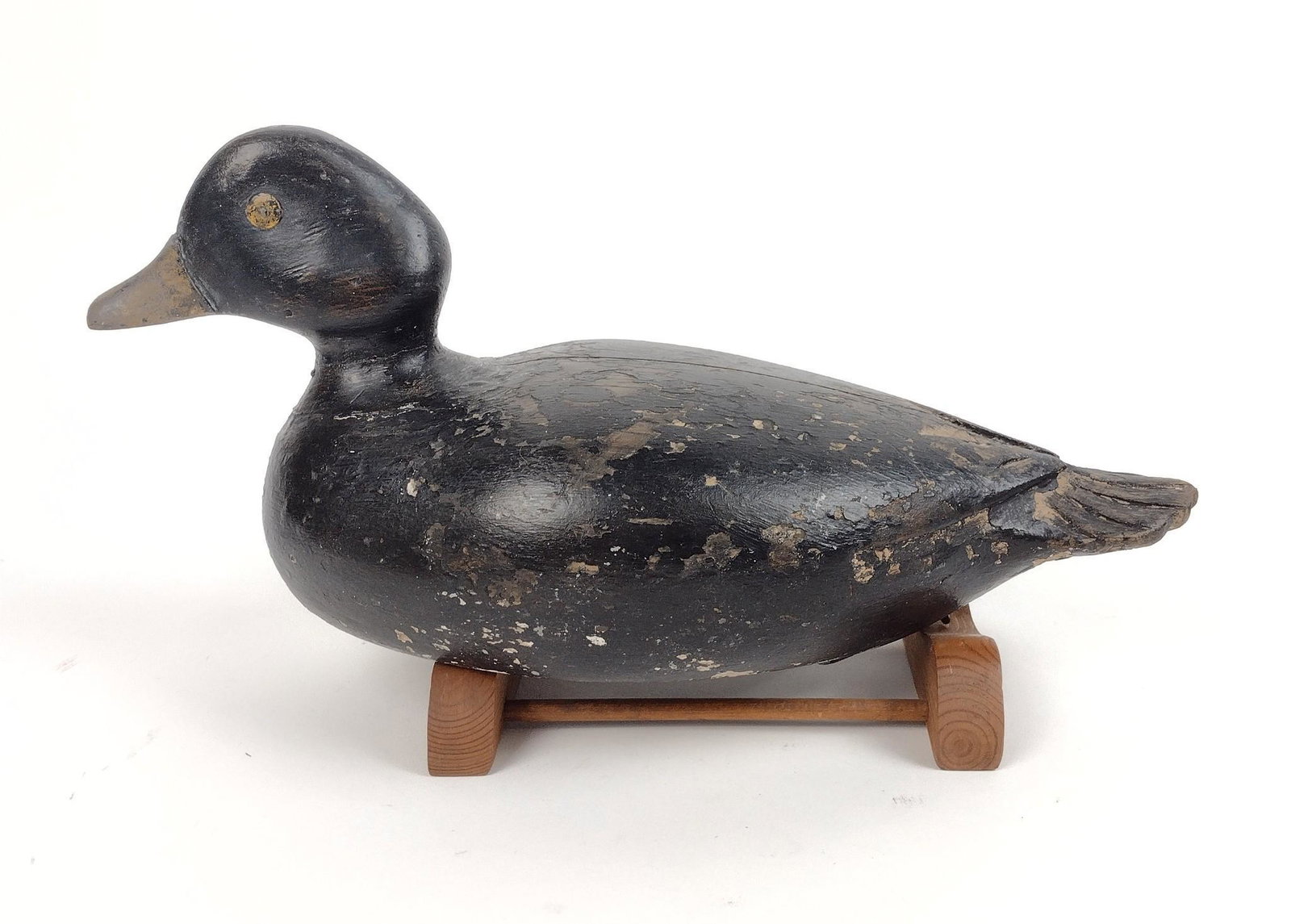 Antique Duck Decoy: Unsigned. 12-3/4" long X 5-1/2" high. Some paint loss. MEG IMPORTANT: Before bidding, please read the terms and conditions. When you registered for the auction you agreed to these terms and will be re