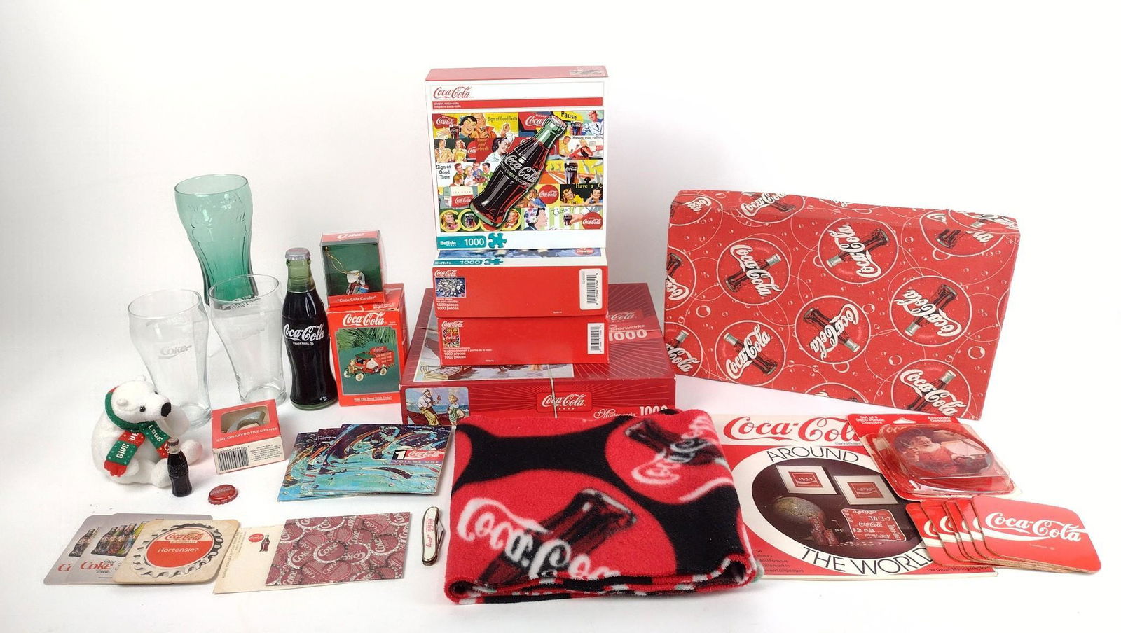33 Pcs Coca-Cola Memorabilia incl Glasses: Also includes ornaments, coasters, puzzles, and more. MEG IMPORTANT: Before bidding, please read the terms and conditions. When you registered for the auction you agreed to these terms and will be req
