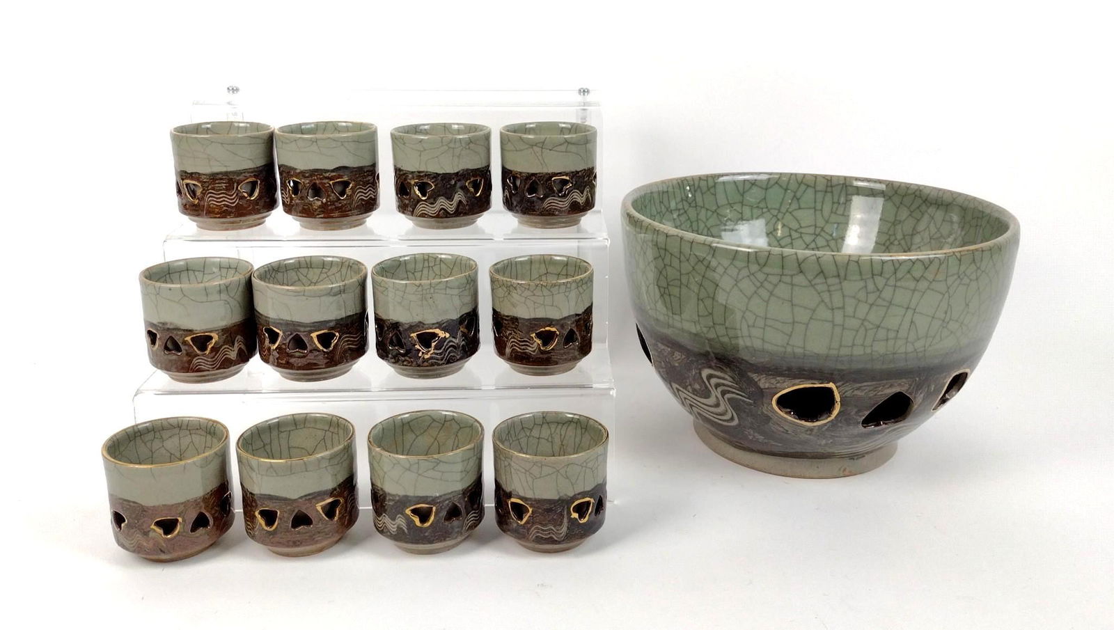 Somayaki Somaware Bowl & 12 Tea Cups: 2-3/4" to 10-3/4" diameter X 2-3/4" to 7" high. One cup has been repaired. IMPORTANT: Before bidding, please read the terms and conditions. When you registered for the auction you agreed to these term