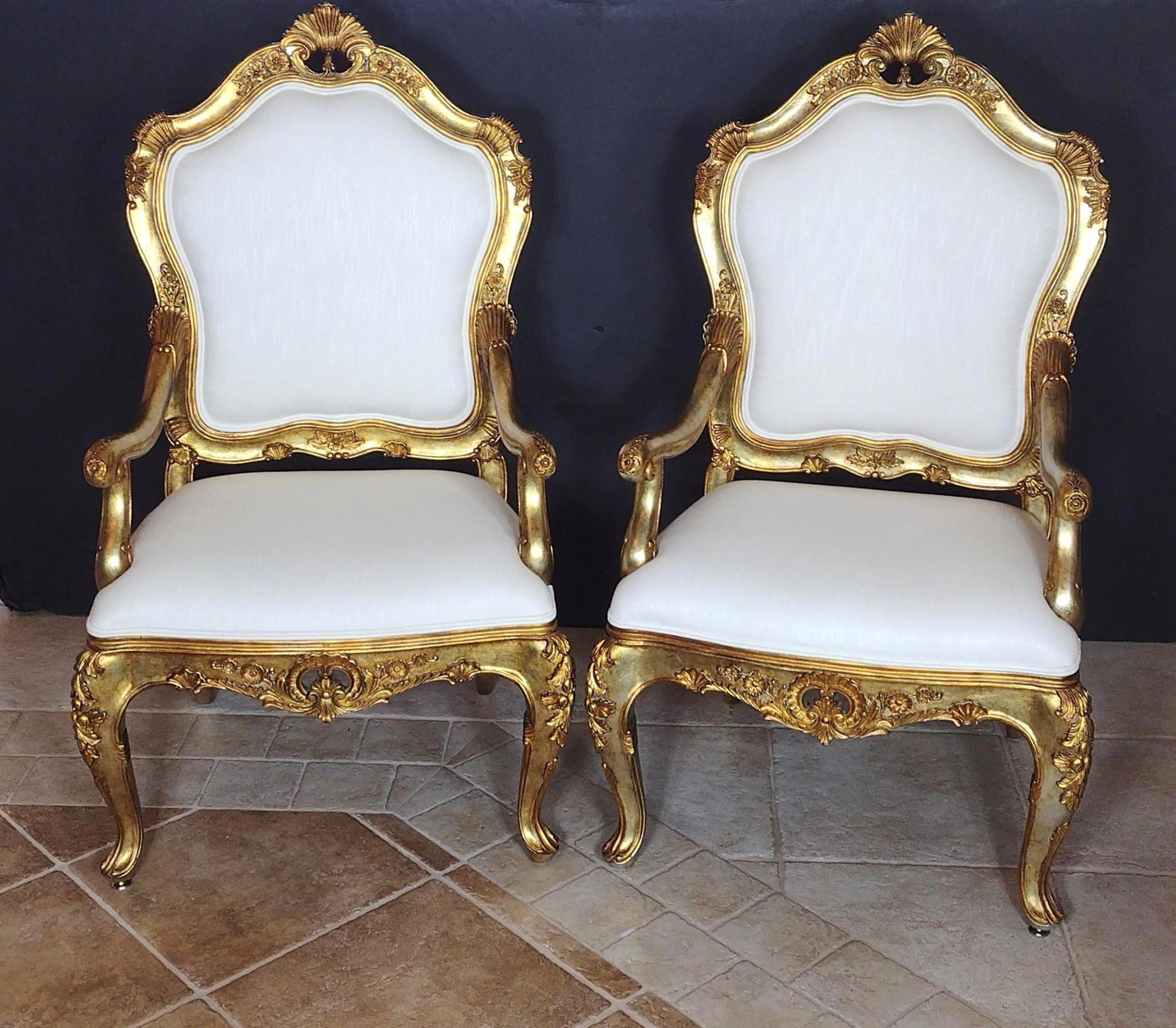 Pair Of Louis XV Style White and Gold Arm Chairs: Each 28-1/2" wide X 26" deep X 48-1/4" high. No manufactures name found. MG. IMPORTANT: Before bidding, please read the terms and conditions. When you registered for the auction you agreed to these te