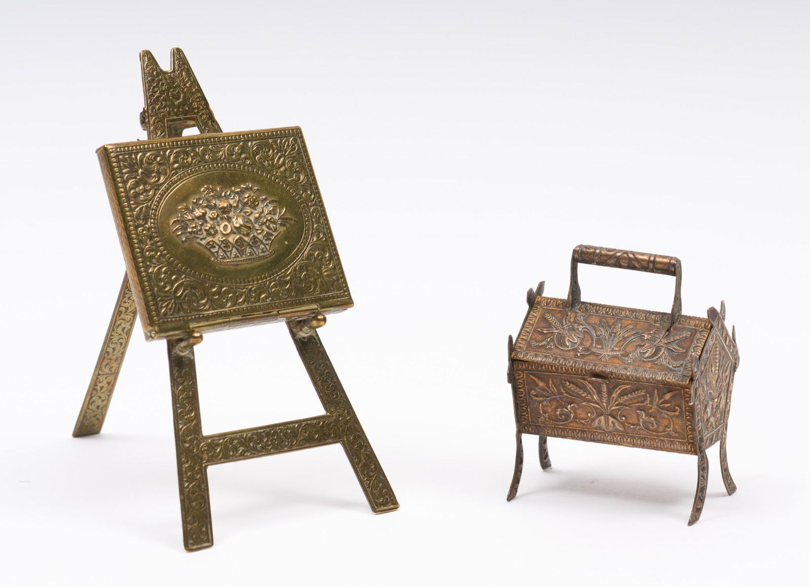 2 19th C Brass W. Avery & Son Figural Needle Cases Incl Easel: DESCRIPTION: Includes figural brass portfolio with floral center atop of a decorative easel and a figural wheat and leaf design raised box. Both 19th century and both marked W. Avery & Son Reddich