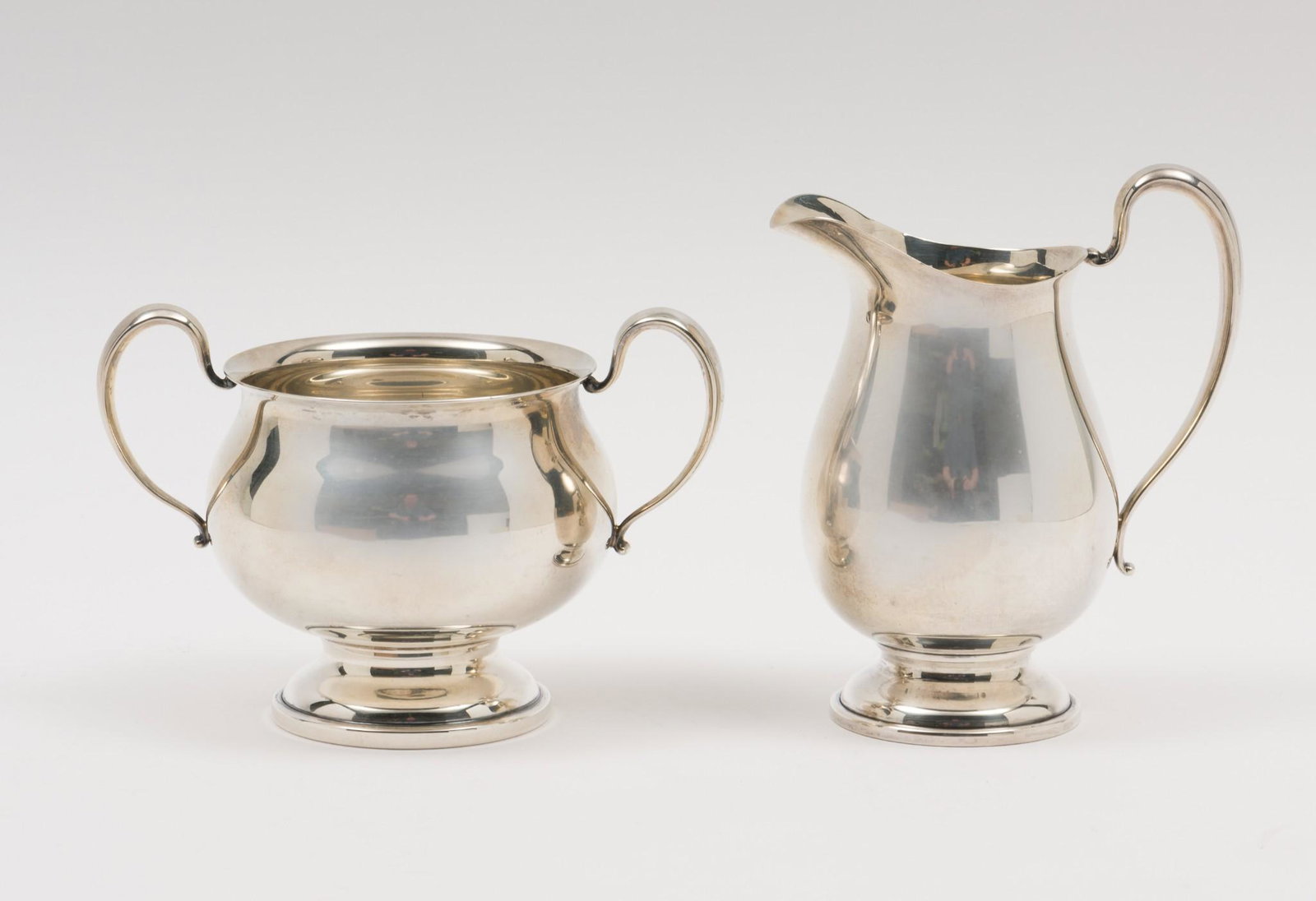 Ellmore Sterling Creamer And Sugar Bowl: Tea service creamer and sugar bowl. Both marked Ellmore 1714 and sterling on bottom. 3-3/8" and 4-1/2" high. 6.9 ozt. Light scuffing and wear as expected with careful use. AJ. IMPORTANT: Before biddin