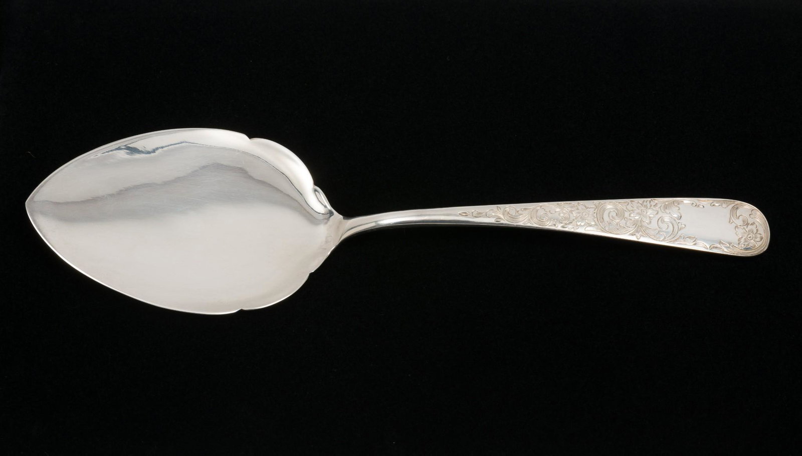 S. Kirk & Son Sterling Pie Knife: Sterling pie knife with floral design to handle. Marked sterling and S. Kirk & Son. 10-1/8" long. 3.6 ozt. Light wear as expected with careful use. AJ. IMPORTANT: Before bidding, please read the terms