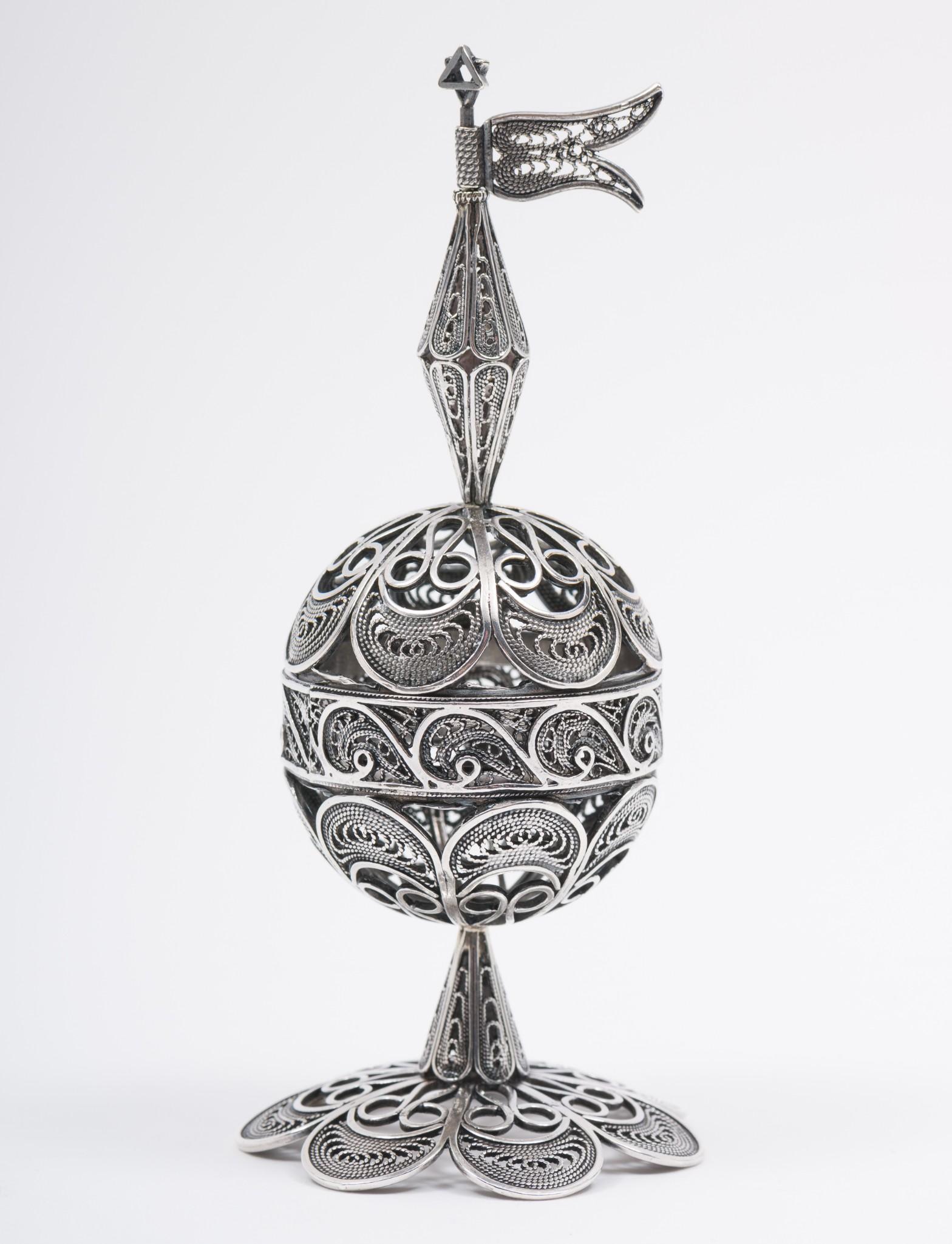 Sterling Havdalah Besamim Spice Holder With Star Of David & Moveable Flag: Judaica egg-shaped Besamim for Havdalah in the Yemenite style with removable top. Includes a moveable flag and Star of David to top. Marked .925 on bottom of base. 4-3/8" high x 1-3/4" diameter. 1.5 o