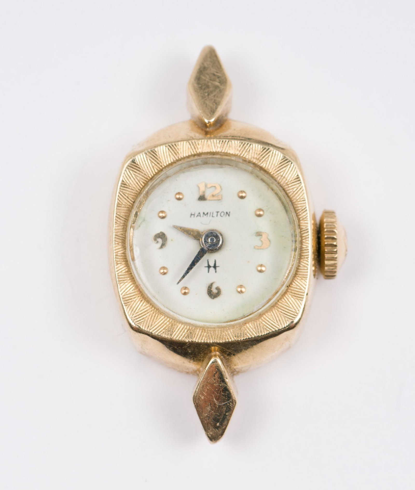 14K Gold Hamilton Watch: Marked 14k. 4.5 dwt. 3/4" wide x 1" long. No band. Running. Case with a crystal. 2.4 dwt. MEG IMPORTANT: Before bidding, please read the terms and conditions. When you registered for the auction you a