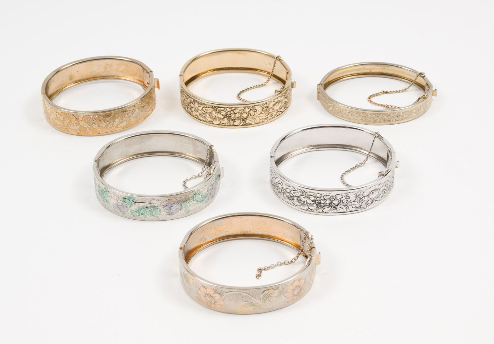 6 Hinged Bangle Bracelets Incl. Coro: Includes floral designs. Two marked Coro. 2-1/8" interior diameter. 1/4" to 5/8" wide. One missing safety chain. AJ. IMPORTANT: Before bidding, please read the terms and conditions. When you registere