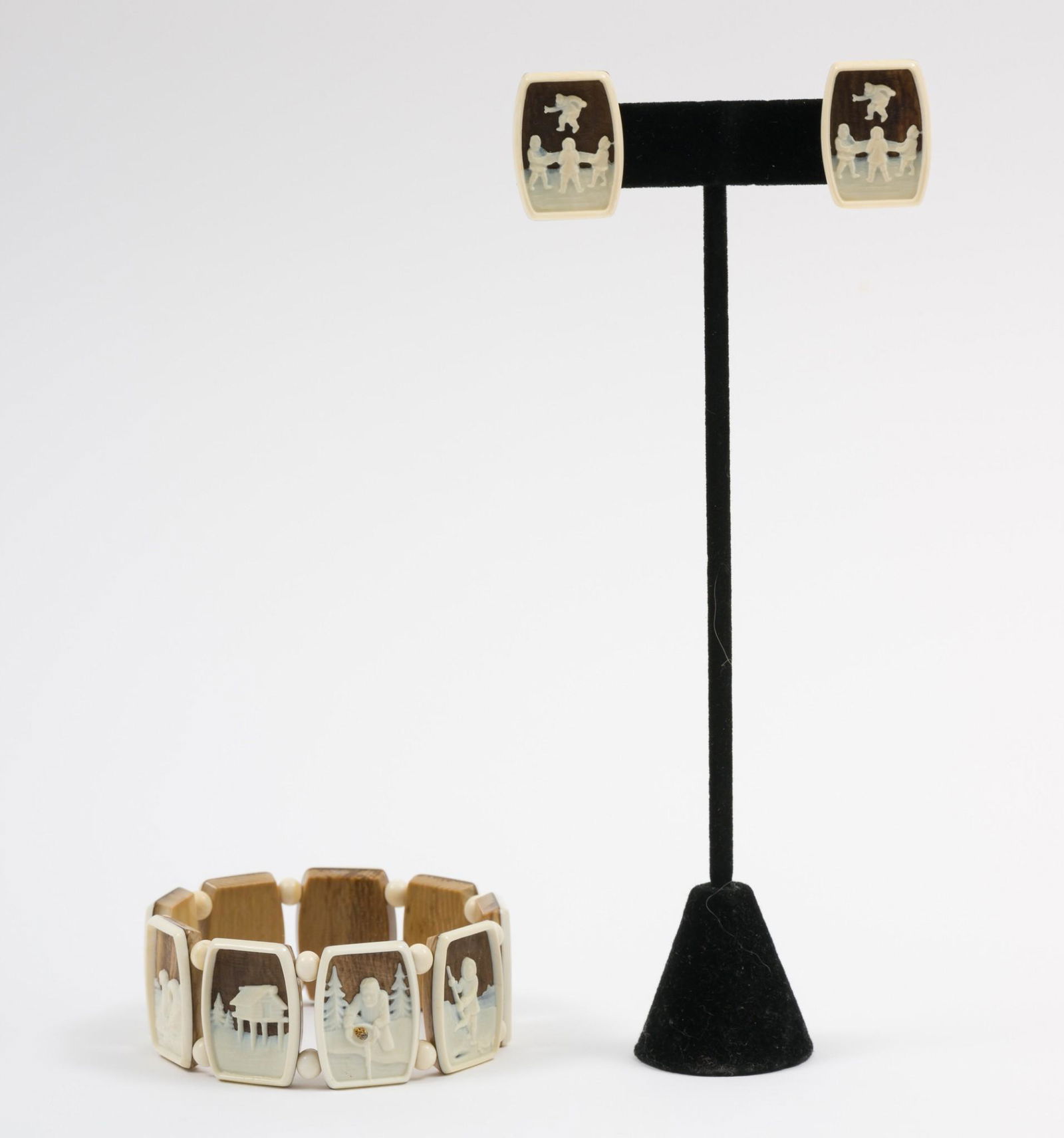 Mayar Alaska Bracelet And Earrings: Includes pair of clip on earrings and panel bracelet. Bracelet includes moose, polar bear, dog sledding, seal, walruses, gold panning, log cabin, ice fishing, and Eskimos scenes. Clip on earrings with