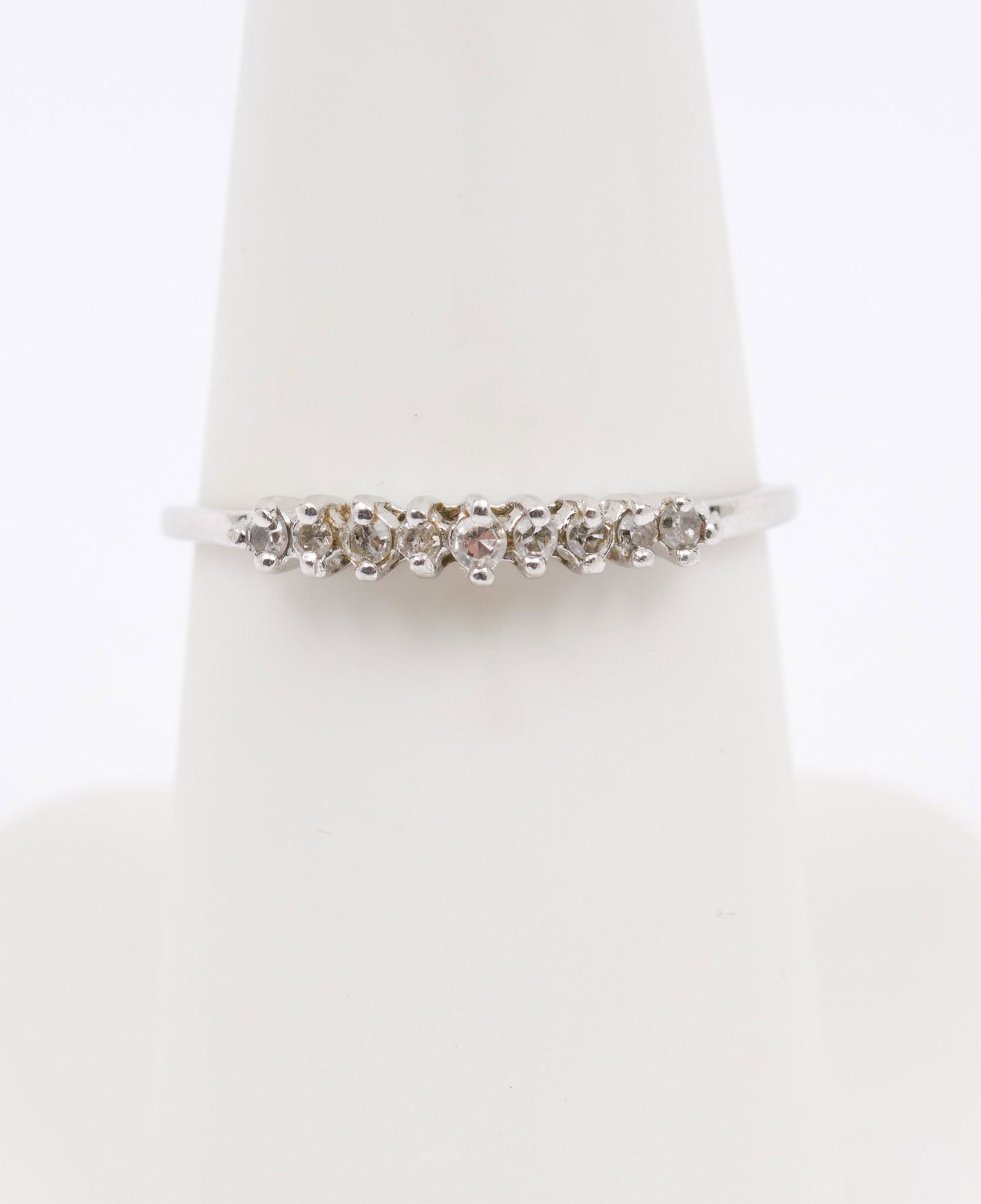 Antique 18K White Gold and Diamond Ring: Antique marked 18k white gold ring set with nine single cut diamonds each .02 carat. Clarity VS2, Color H-I. Size 6-1/2. .9 dwt. MH/EK IMPORTANT: Before bidding, please read the terms and conditions. 