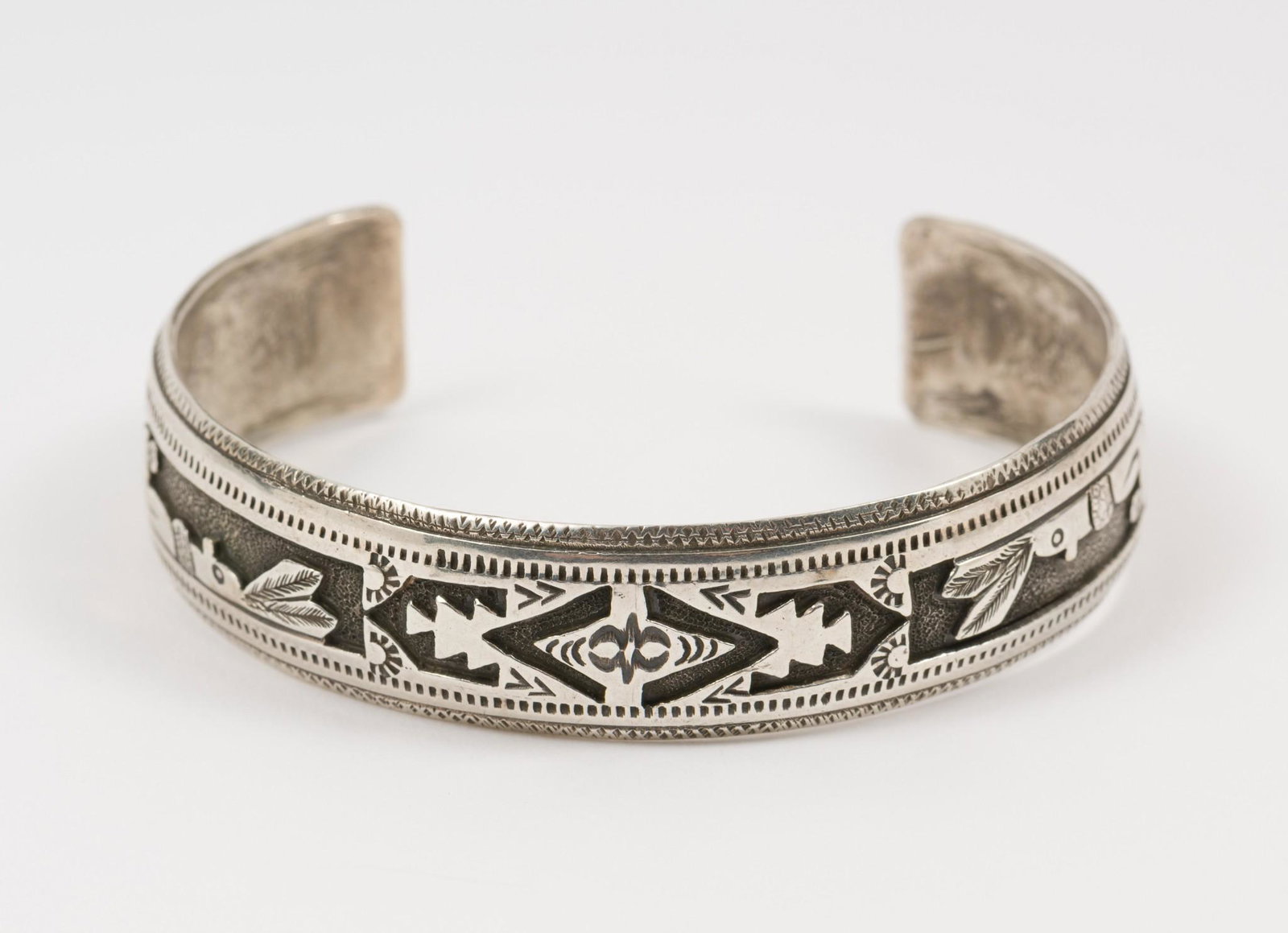 Hopi Sterling Engraved Cuff: Hopi sterling engraved cuff featuring clown kachina decoration. 1/2" wide, 2-1/2" interior diameter. MH. IMPORTANT: Before bidding, please read the terms and conditions. When you registered for the au