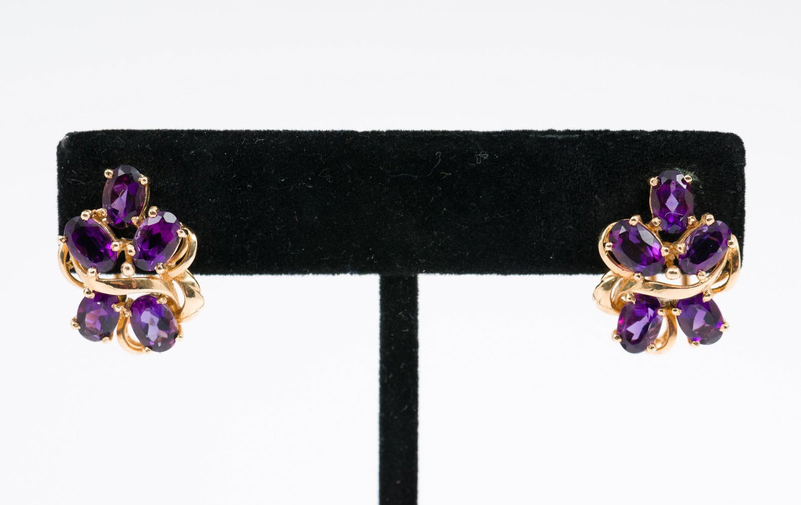 14K Gold and Amethyst Earrings: Marked 14K gold earrings each set with five approximately .15 carat each oval cut amethyst. Pierced French backs. 3/4" long. 3.7 dwt. MH/EK IMPORTANT: Before bidding, please read the terms and conditi