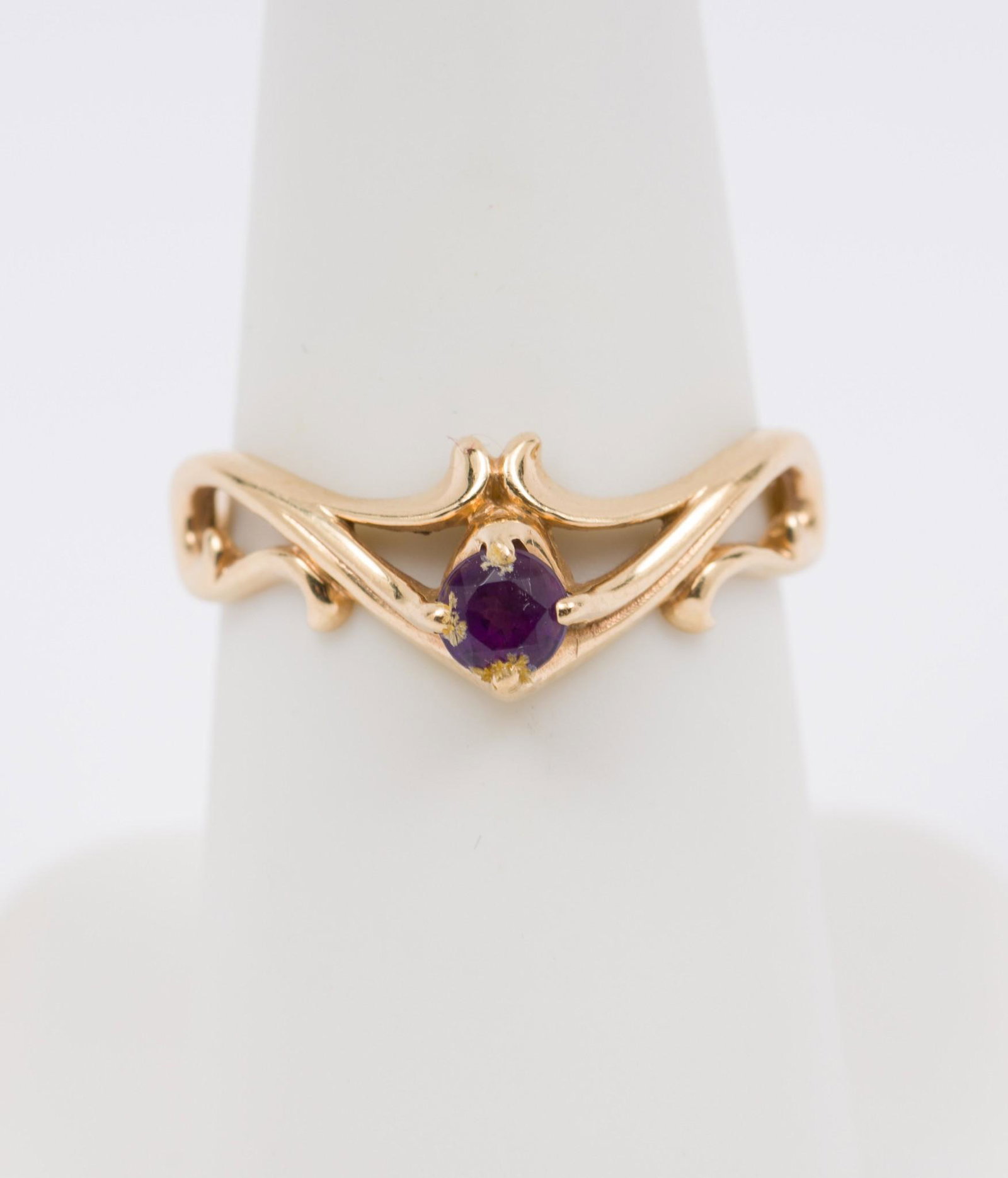 14K Yellow Gold Scrolled Amethyst Ring: Tested 14K yellow gold ring set with round cut amethyst. Stamped KBN for Kabana. 1/4" wide. Size 7. Has been sized. Some wear to stone. 1.6 dwt. MH/EK IMPORTANT: Before bidding, please read the terms 
