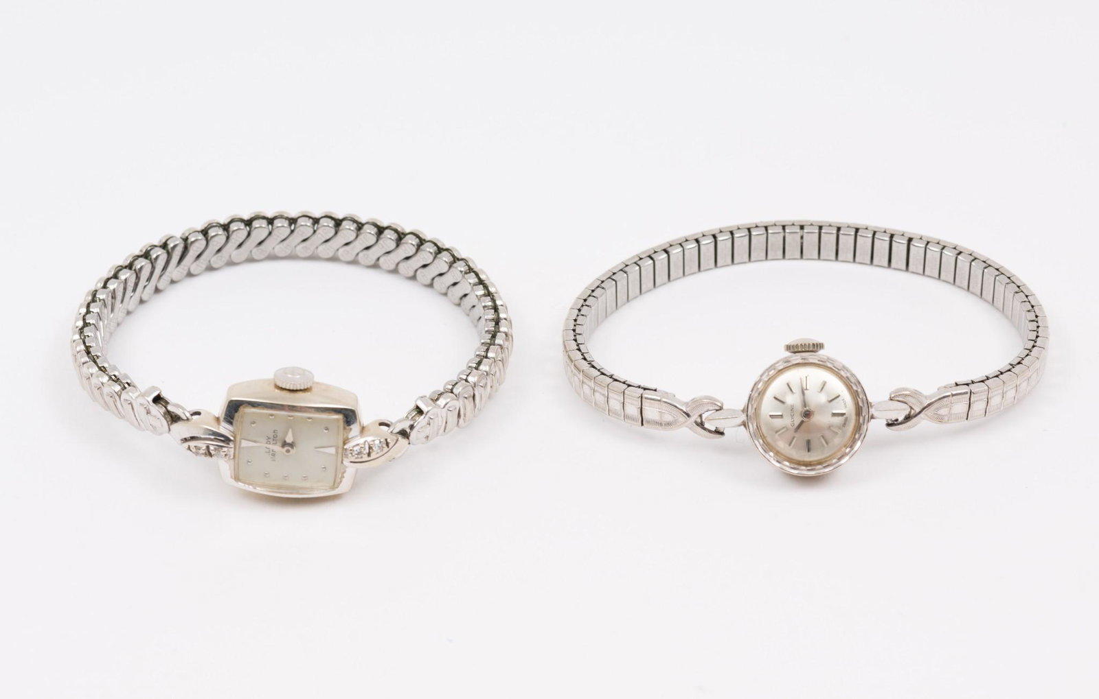 2 14k Women's Wristwatches: Lady Hamilton with diamond accents. Glycine marked 14k. Both elastic bands. MEG IMPORTANT: Before bidding, please read the terms and conditions. When you registered for the auction you agreed to these