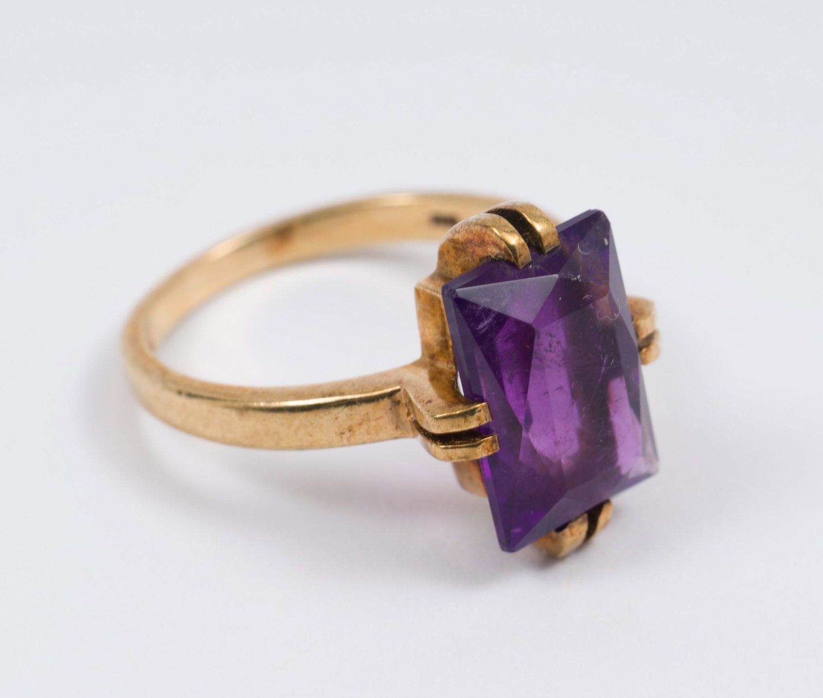 9K Gold and Amethyst Ring: 9k gold antique setting with 5 carat emerald cut amethyst. Marked 9k (375) and hallmarked. 3.1 dwt. Size 8. 3/4" long. EK IMPORTANT: Before bidding, please read the terms and conditions. When you regi