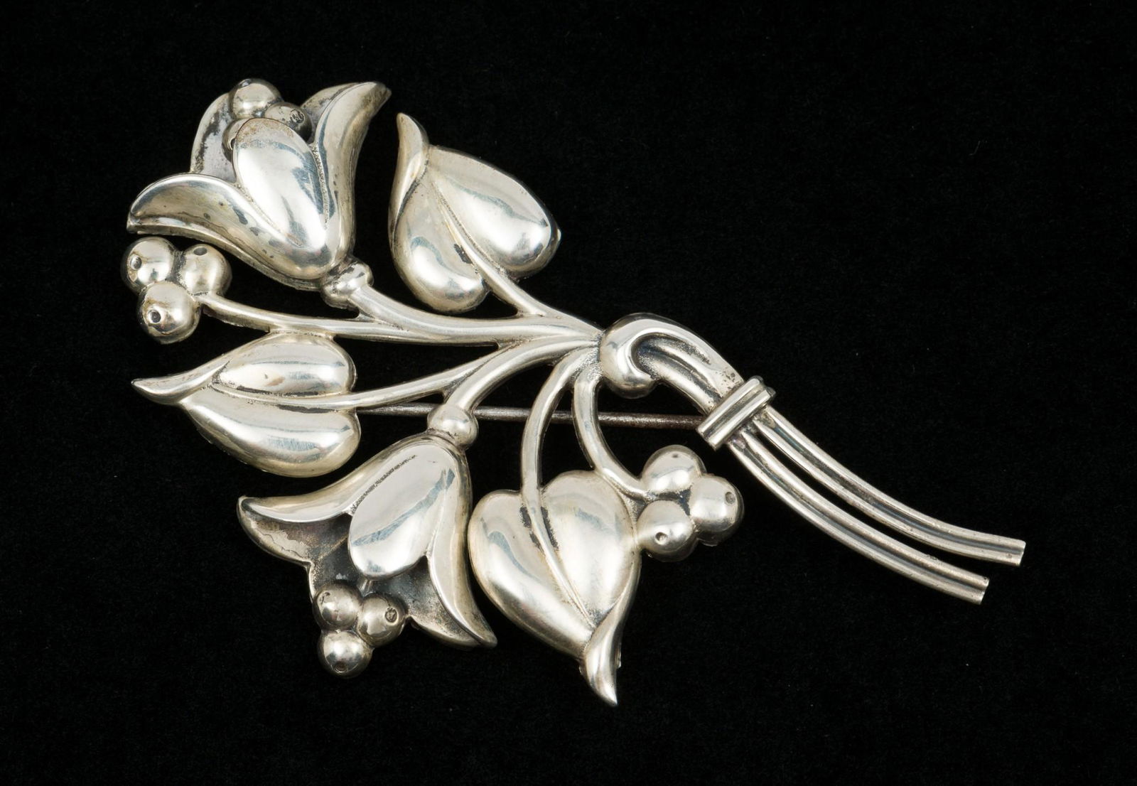 Sterling Coro Floral Brooch: Sterling floral brooch. Marked Sterling. 3" wide x 2" high. MEG IMPORTANT: Before bidding, please read the terms and conditions. When you registered for the auction you agreed to these terms and will
