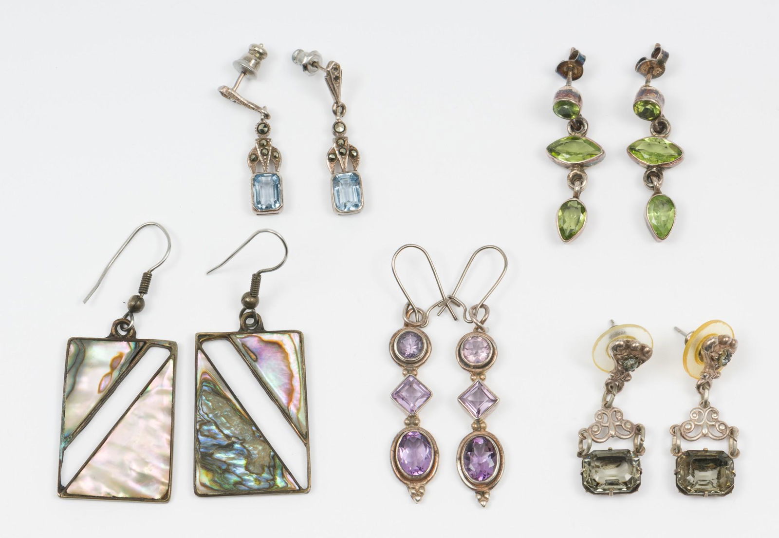 5 Pr. Gemstone Earrings: Includes one pair with blue gemstones, pair with green gemstones, pair brown gemstones, pair with purple gemstones, and abalone inlay. 1-1/4" to 2" long. One pair marked "Alpaca Mexico". MEG IMPORTANT