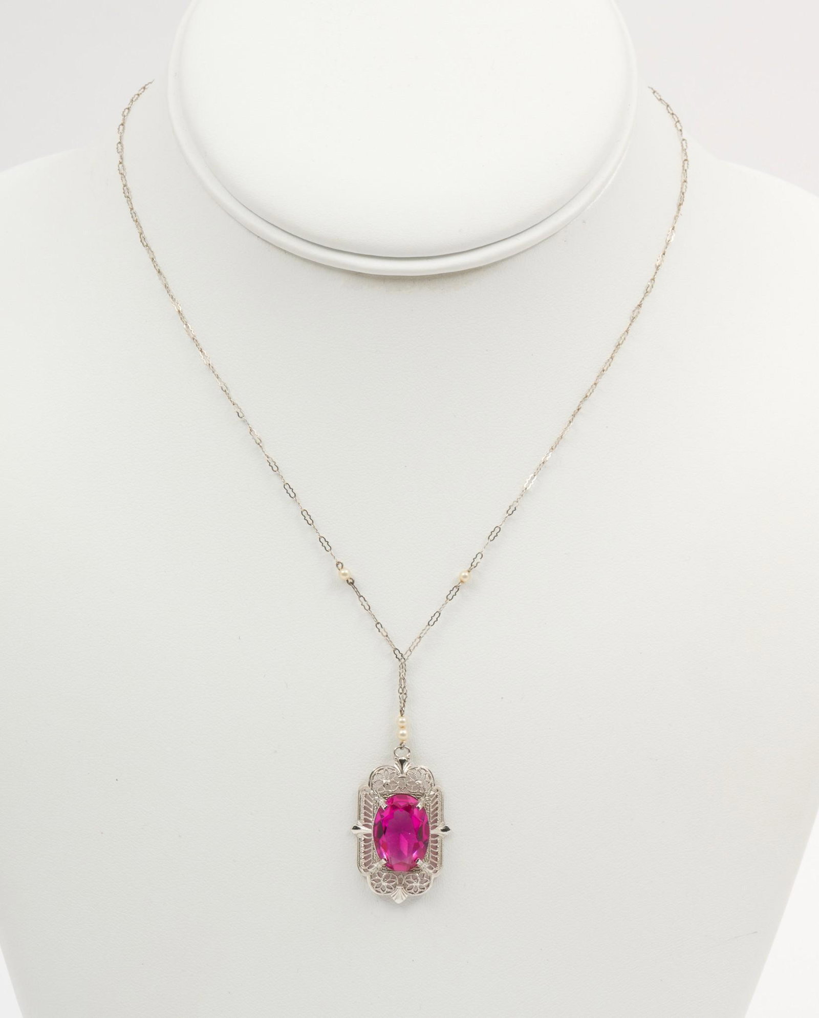10K White Gold & Pink Topaz Pendant Necklace: Marked 10k chain with seed pearls, filigree pendant set with oval cut pink topaz approximately 4.5 carats. 1.7 dwt. 16" chain with 1" long pendant. MEG/EK IMPORTANT: Before bidding, please read the te