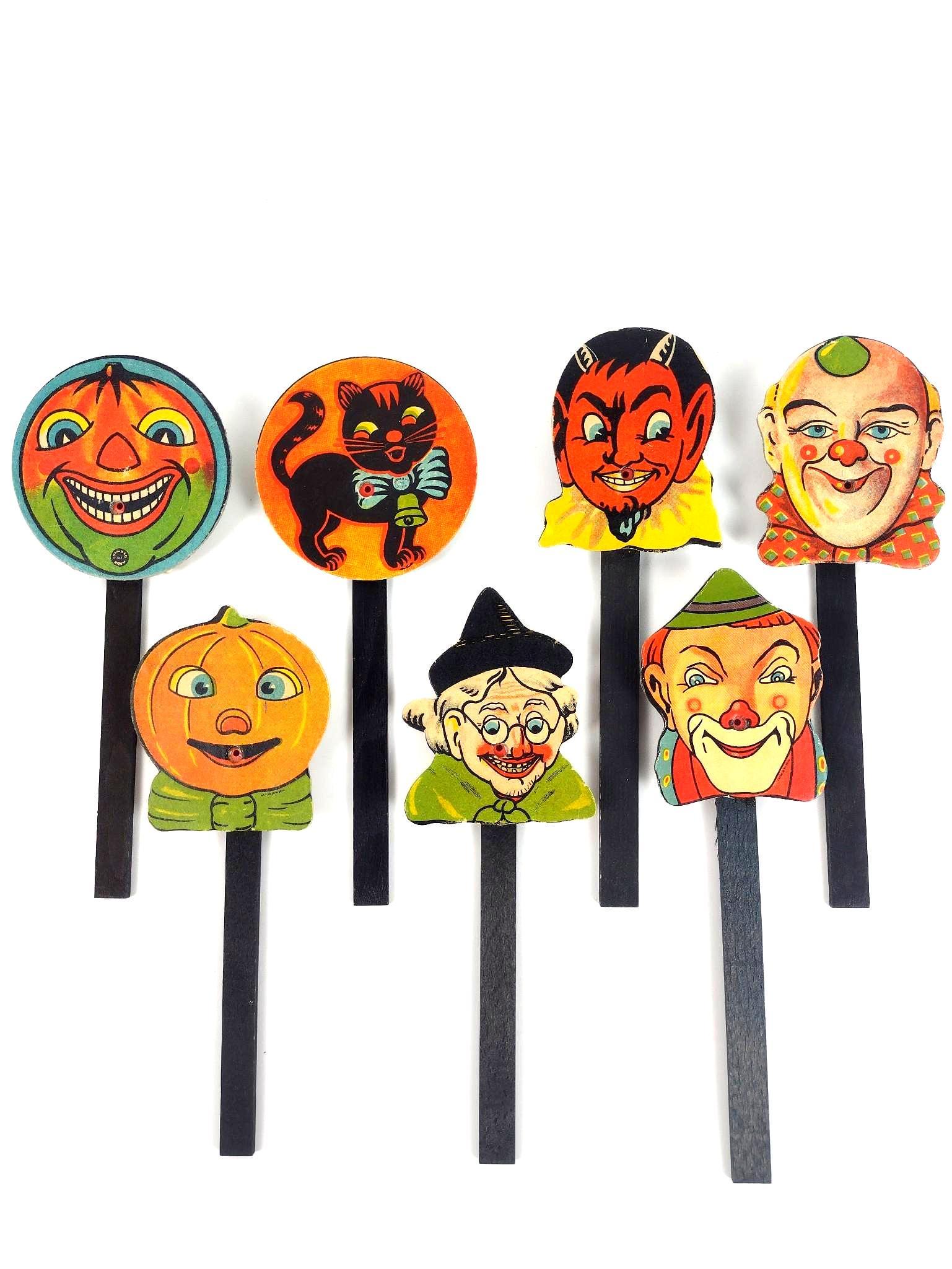 7 West Germany Halloween Whistlers: Each approximately 3" wide X 8-1/2" high. LR From the estate of Robert Harman. IMPORTANT: Before bidding, please read the terms and conditions. When you registered for the auction you agreed to these